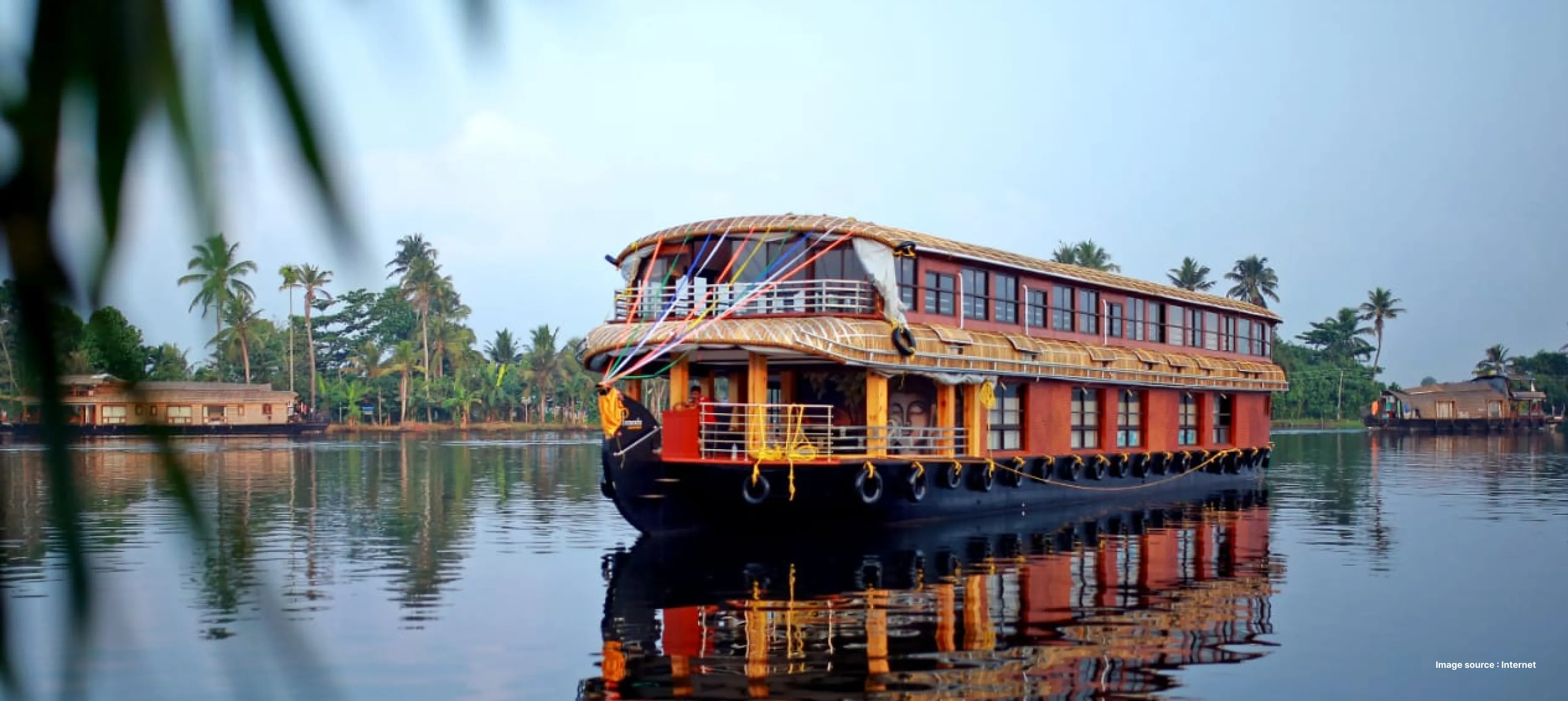 a traditional houseboat cruising down the beautiful backwaters of alleppey