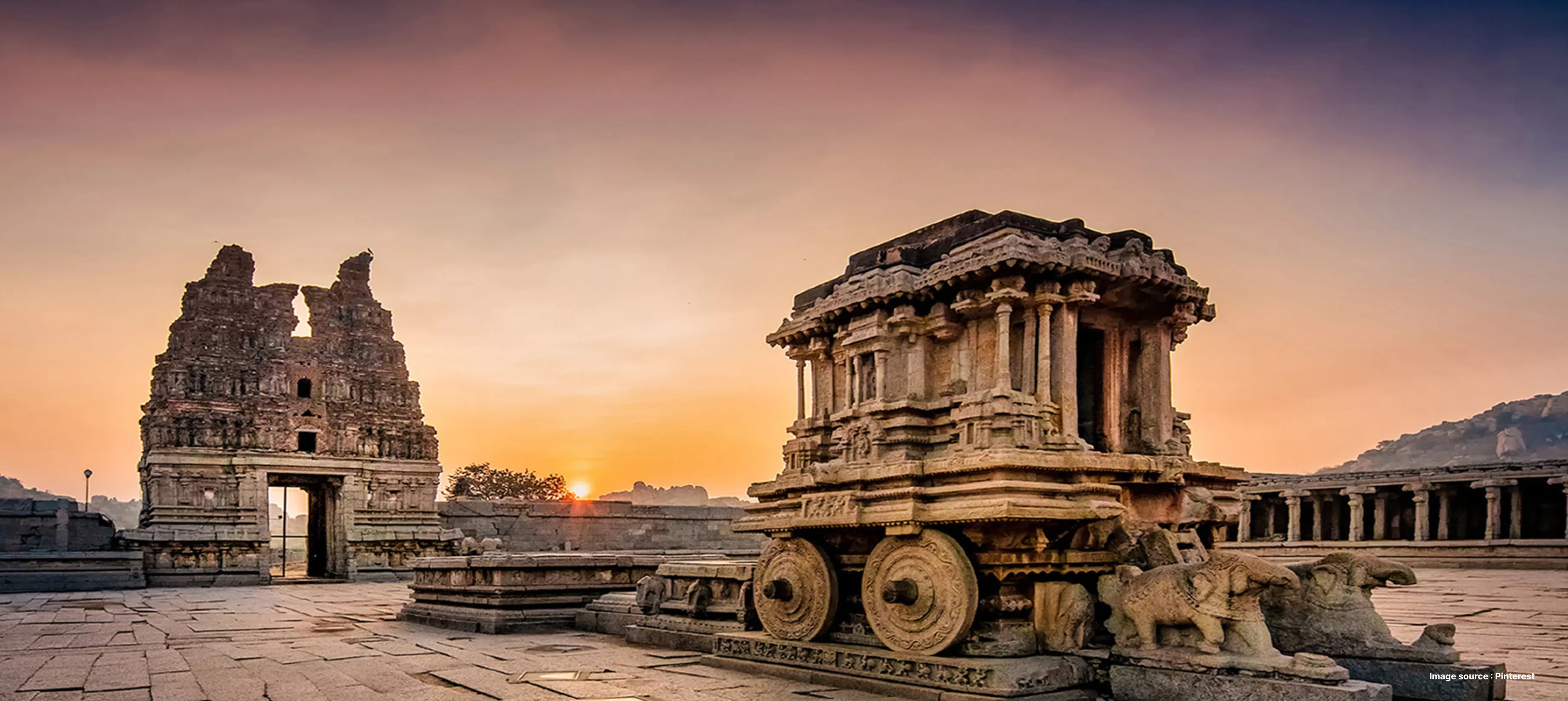 a dramatic landscape of hampi's ancient chariot temple structures at sunset