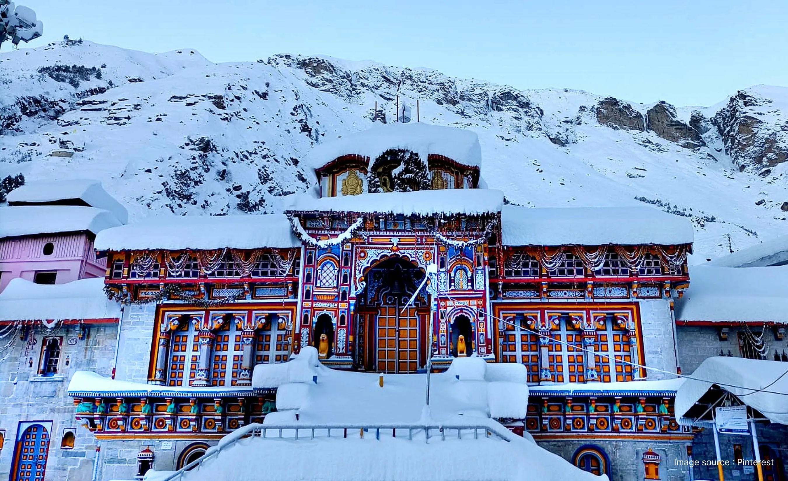 Snow-covered Badrinath Temple in Uttarakhand with colorful Himalayan architecture, winter snowfall, and surrounding mountains