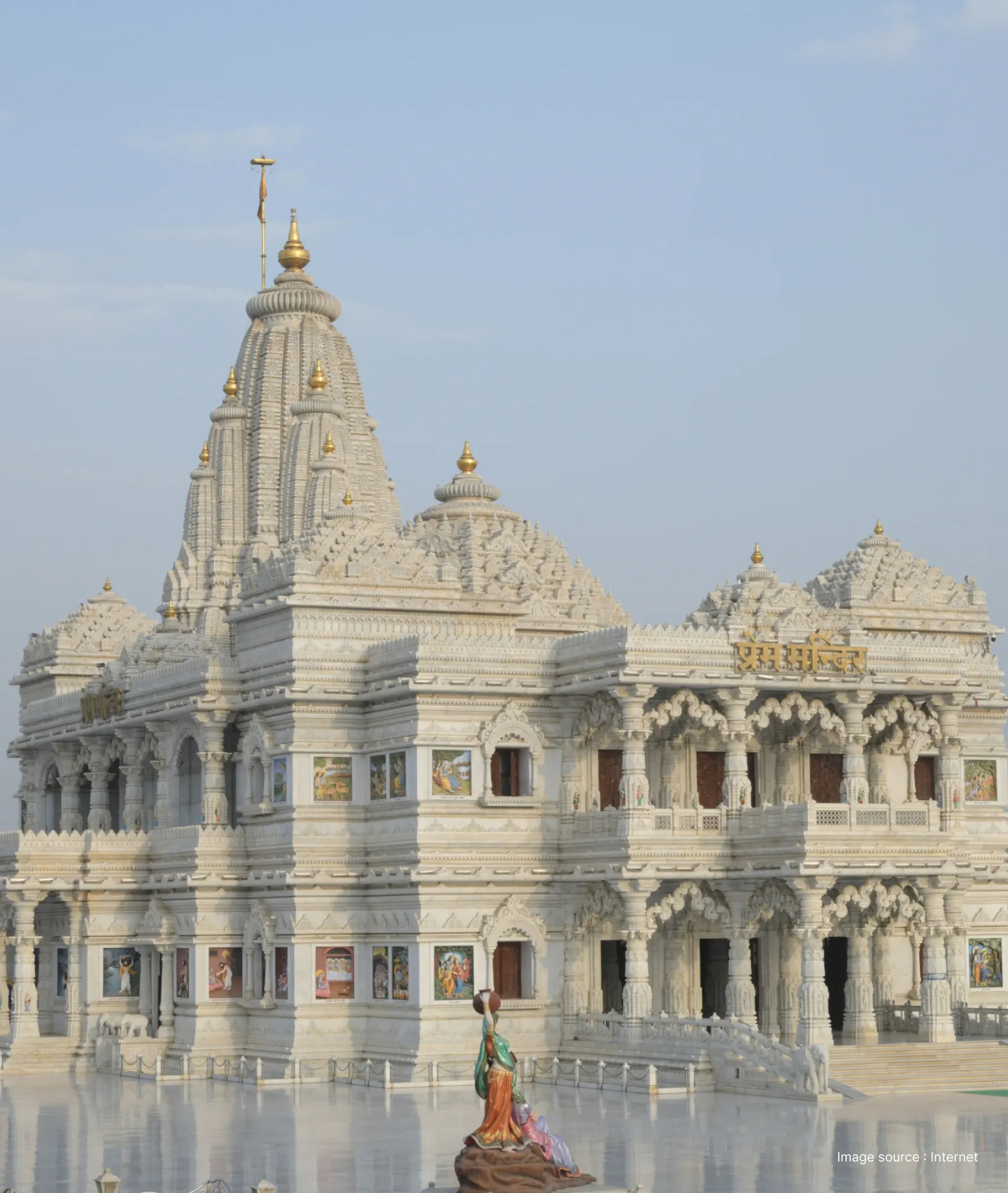 The ornate white marble architecture of Prem Mandir in Vrindavan featuring intricate carvings, multiple levels, and a central grand shikhara.