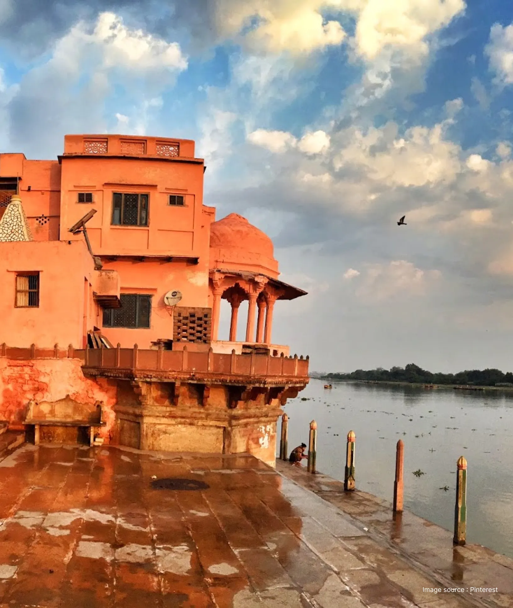 View of the red sandstone heritage building and stone steps at Keshi Ghat on the banks of the Yamuna River in Vrindavan.