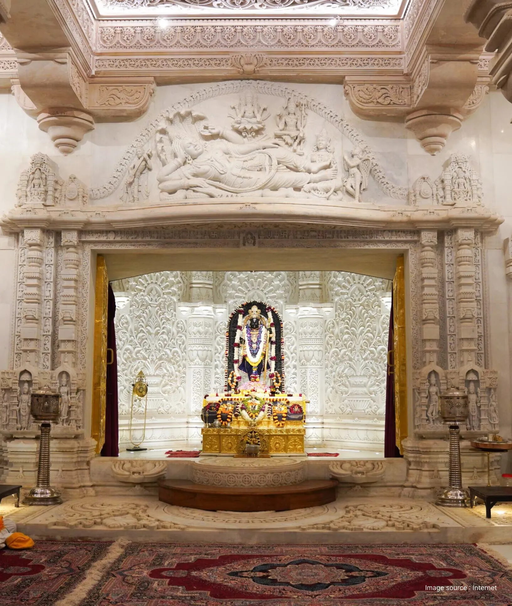 Inner sanctum of Ram Mandir in Ayodhya featuring the beautifully adorned idol of Lord Ram and intricate white marble carvings