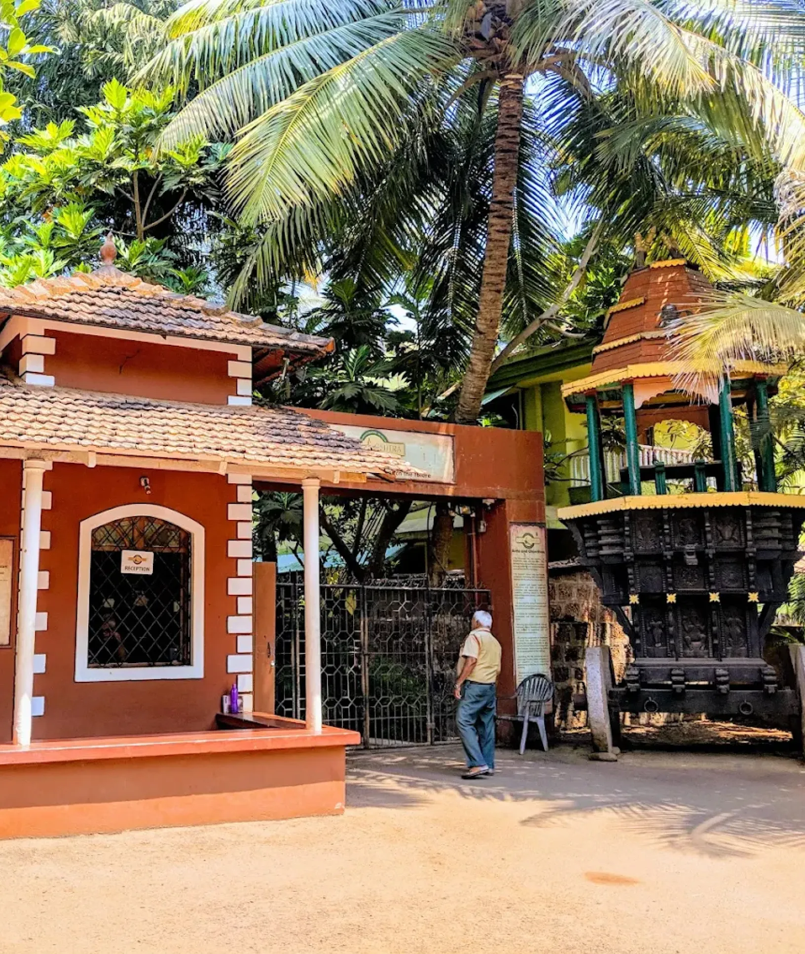 Goa Chitra Museum entrance in South Goa featuring traditional Goan architecture, palm trees, and a historic temple structure within the heritage complex