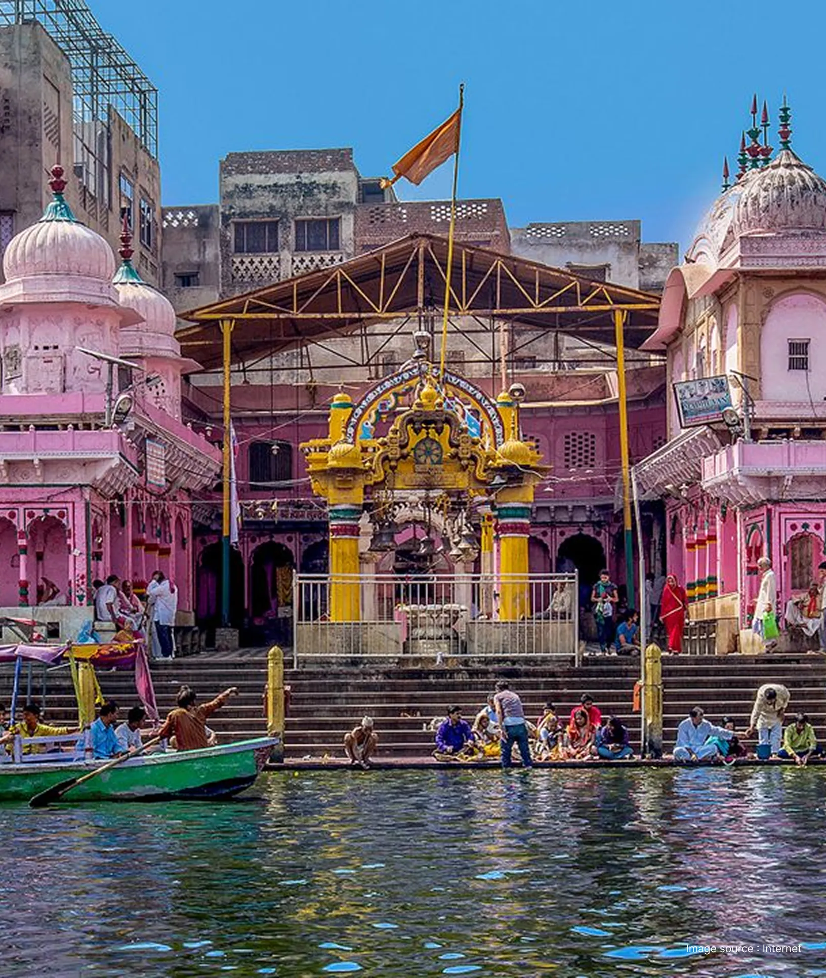 Pilgrims and boats at Vishram Ghat on the banks of the Yamuna River, featuring colorful shrines and traditional steps.