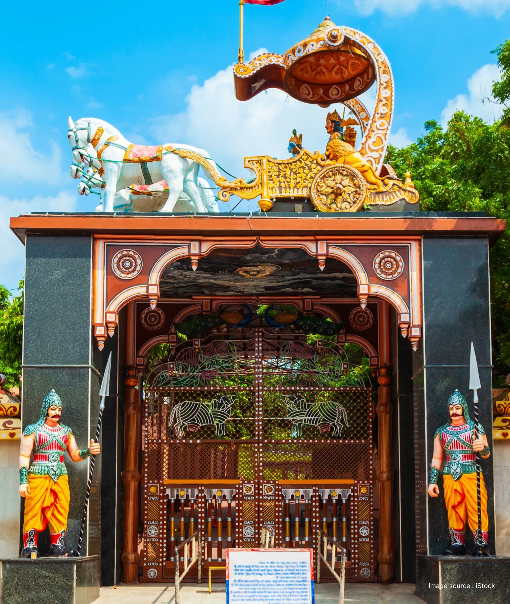 Ornate gateway at Krishna Janmasthan featuring a colorful chariot sculpture of Lord Krishna and Arjuna from the Bhagavad Gita.