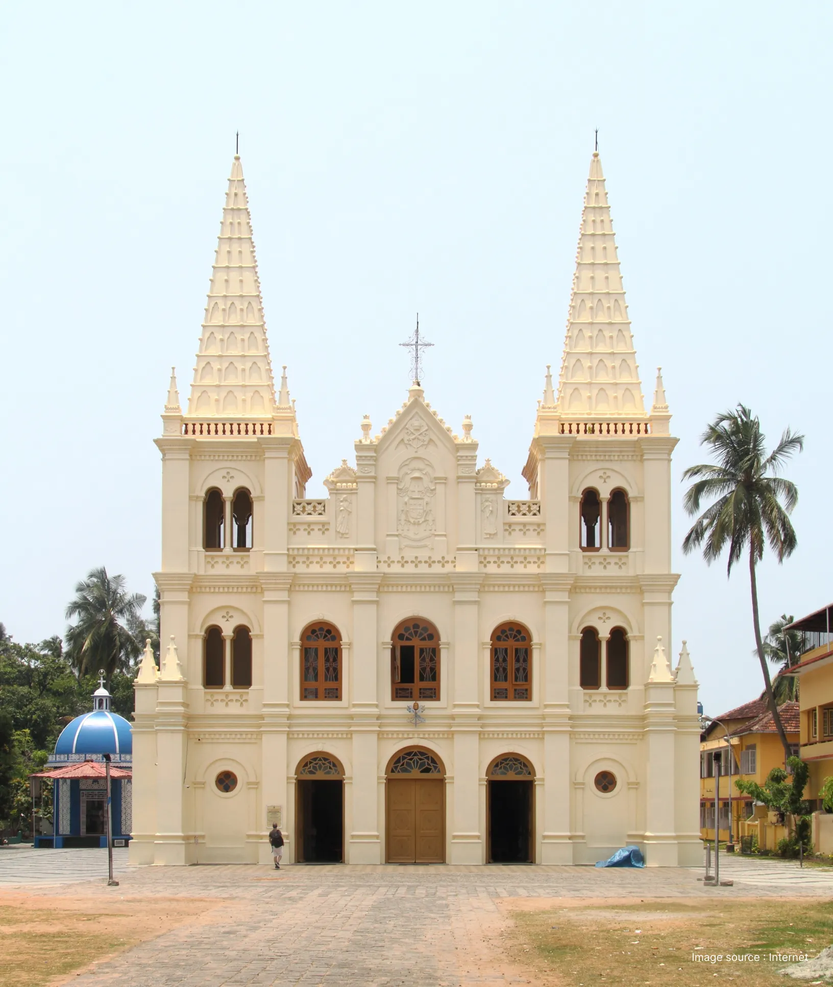 The white Gothic-style facade and twin spires of the Santa Cruz Cathedral Basilica in Fort Kochi, Kerala.