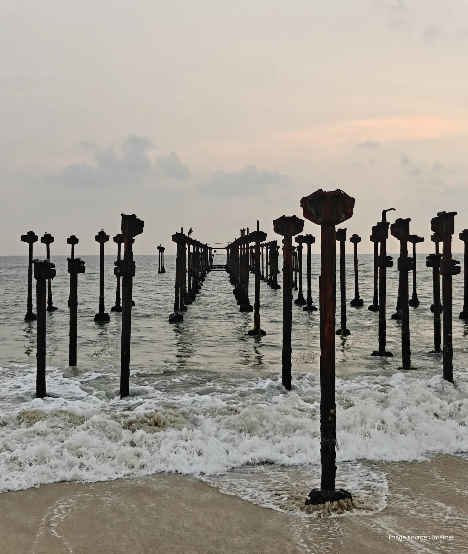 the alleppey beach pier, a 140-year old structure extending into the arabian sea