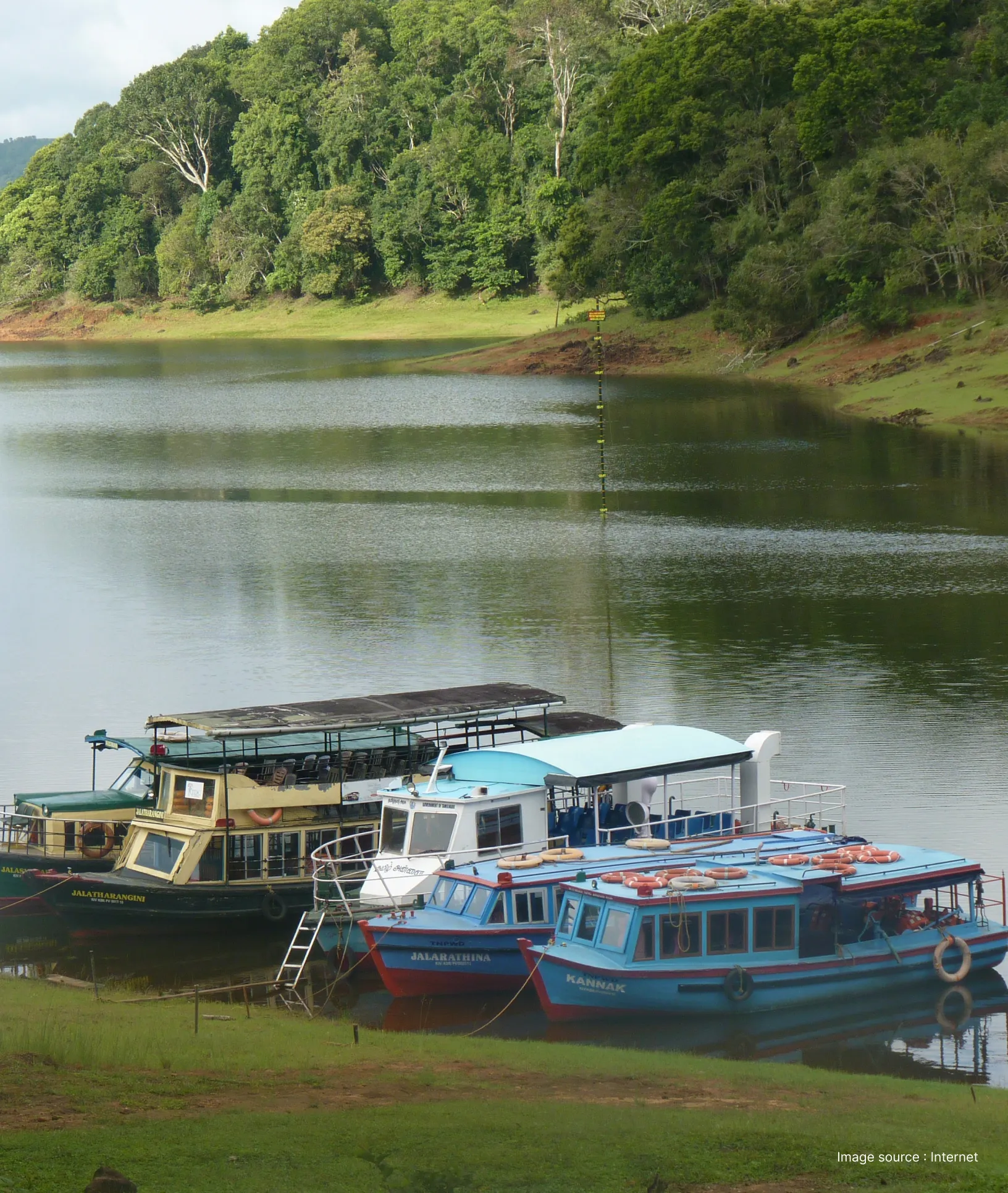 the shore of the periyar lake with multiple boats waiting for afternoon safari