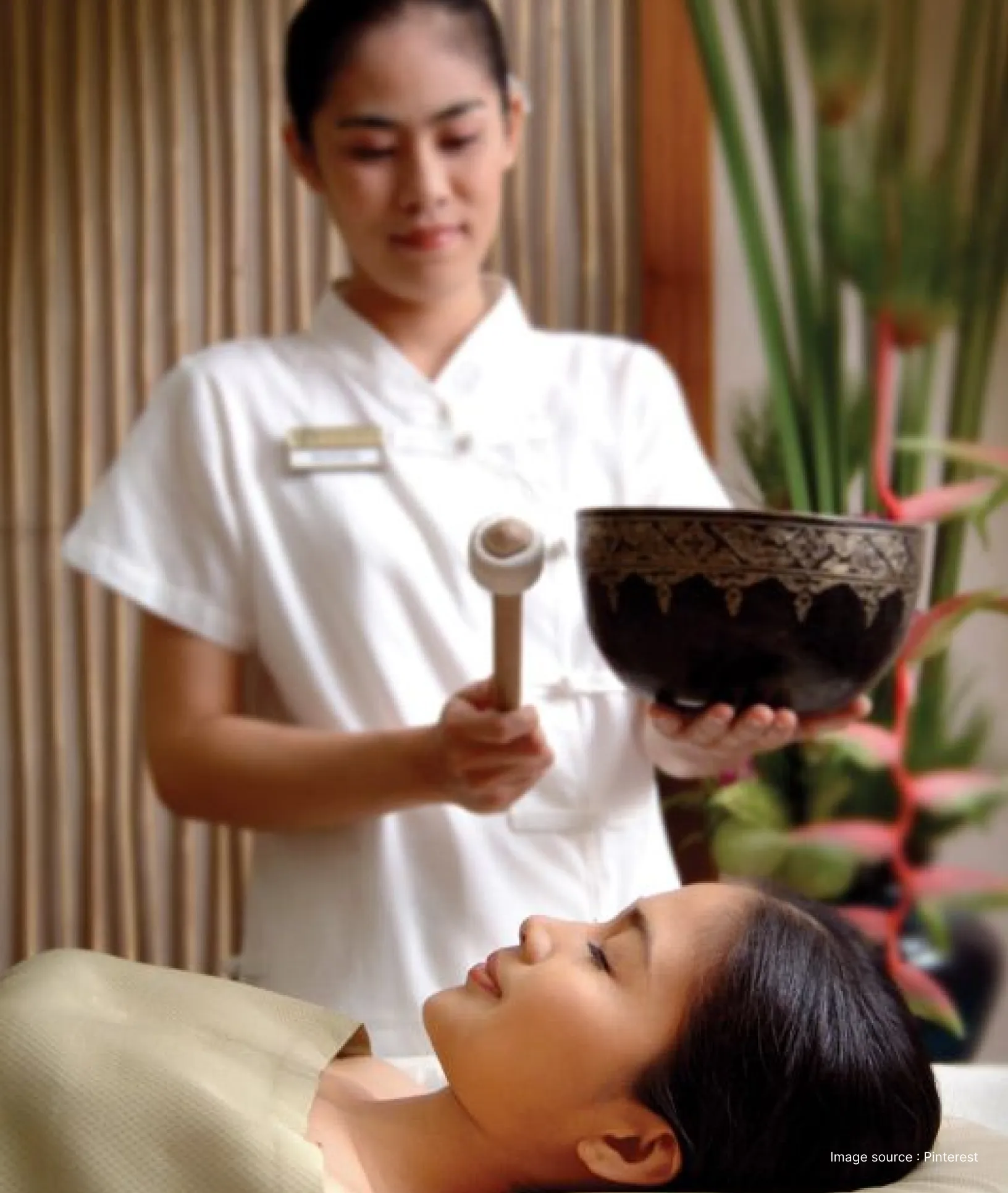A woman enjoying traditional sound based healing therapy in a wellness retreat