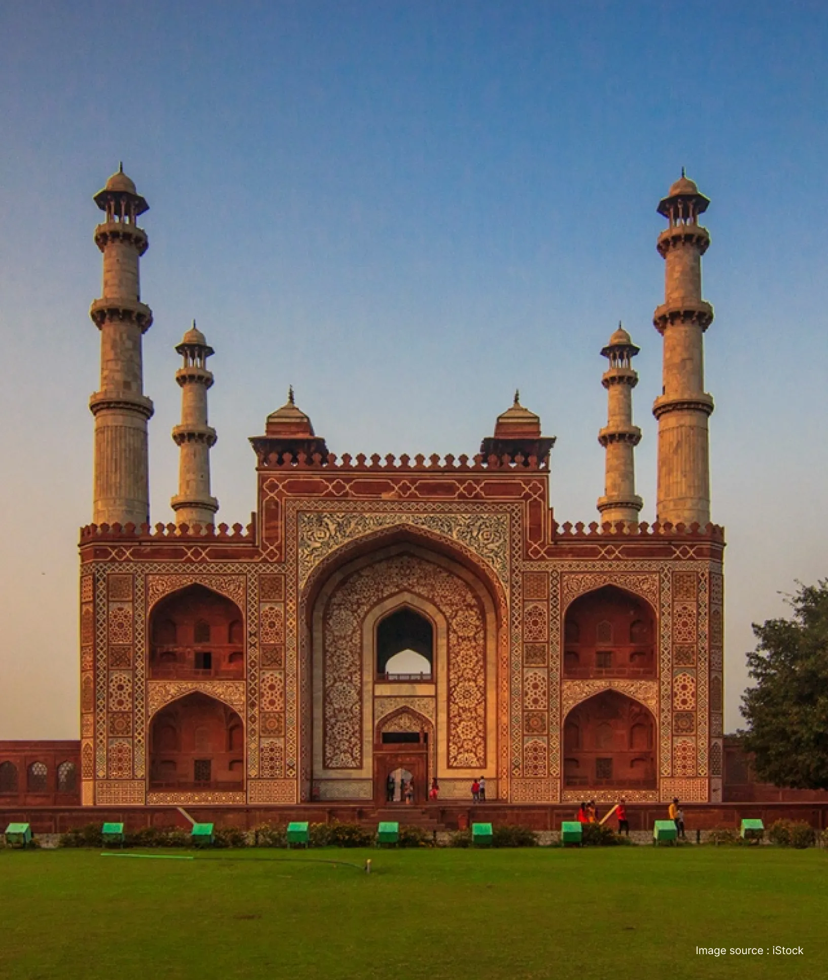 mughal era red sandstone building during the day, akbar's tomb with four pillars