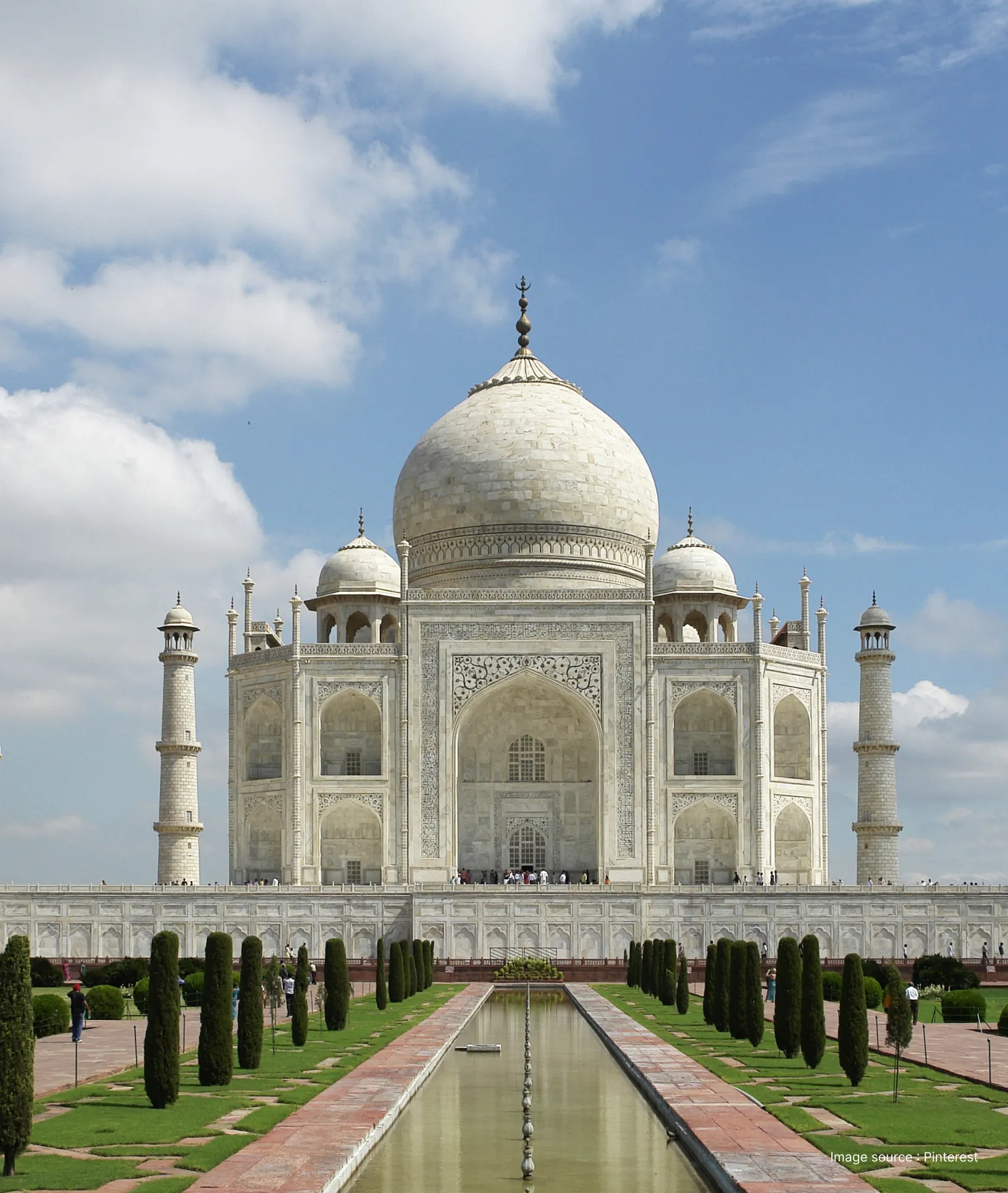 a clear view of the main marble mausoleum of taj mahal in daytime with trees lined in front