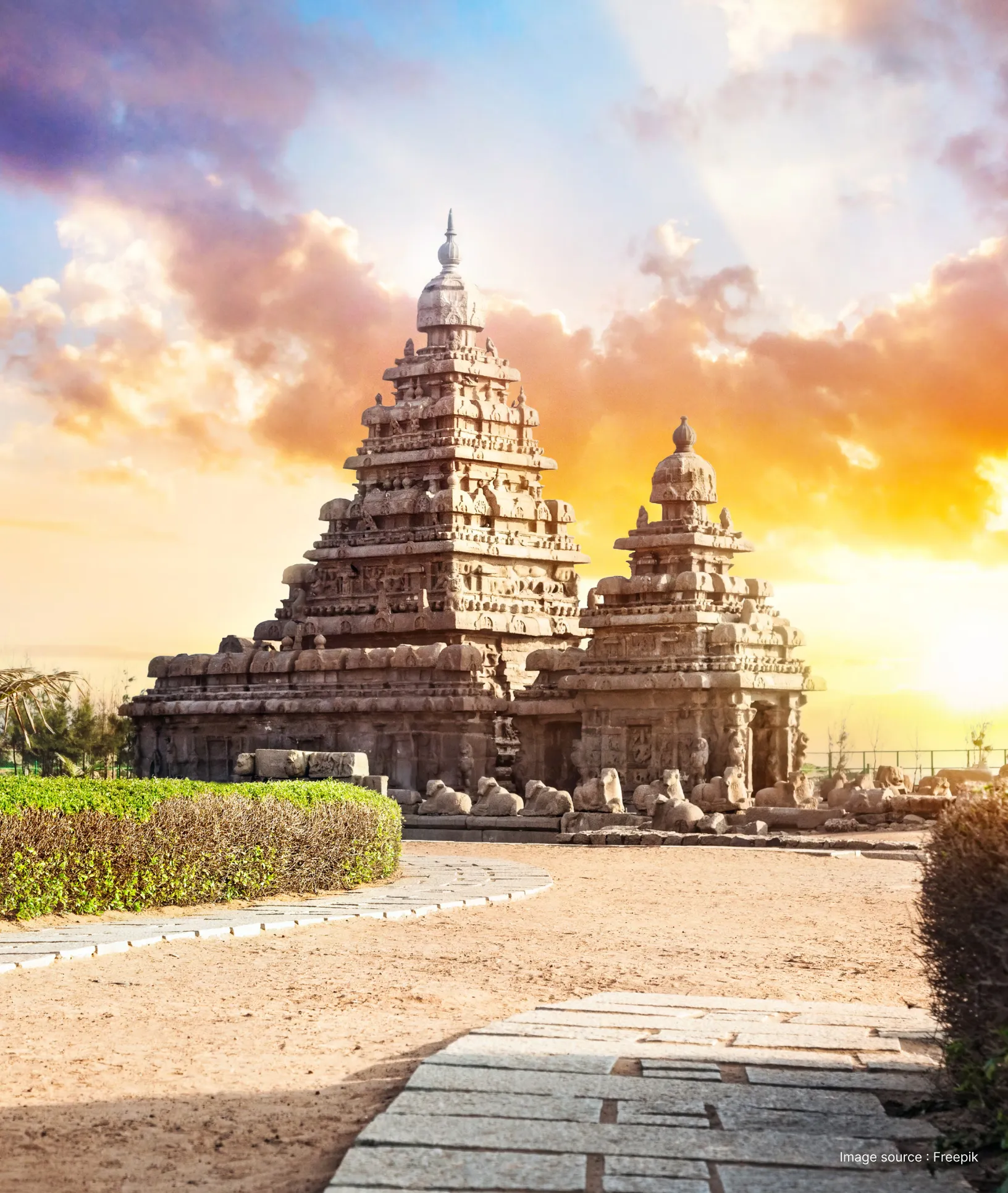 a dramatic picture of the landscape of mahabalipuram at sunset with ancient sandstone shore temple