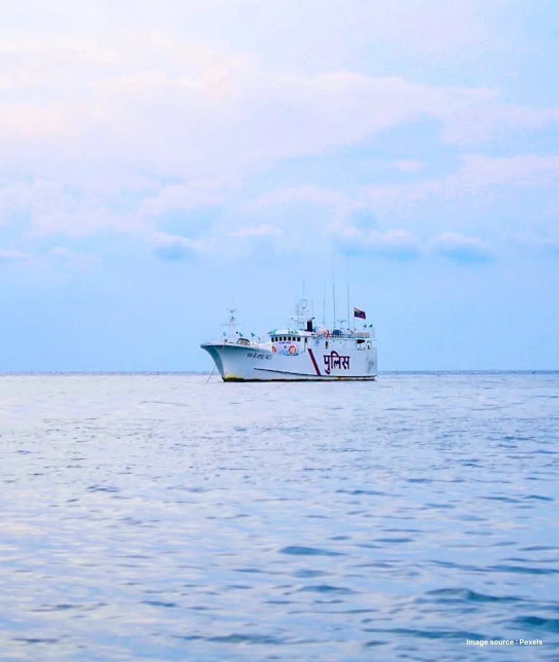 a monochromatic shot of a medium sized boat cruising the waters of andaman