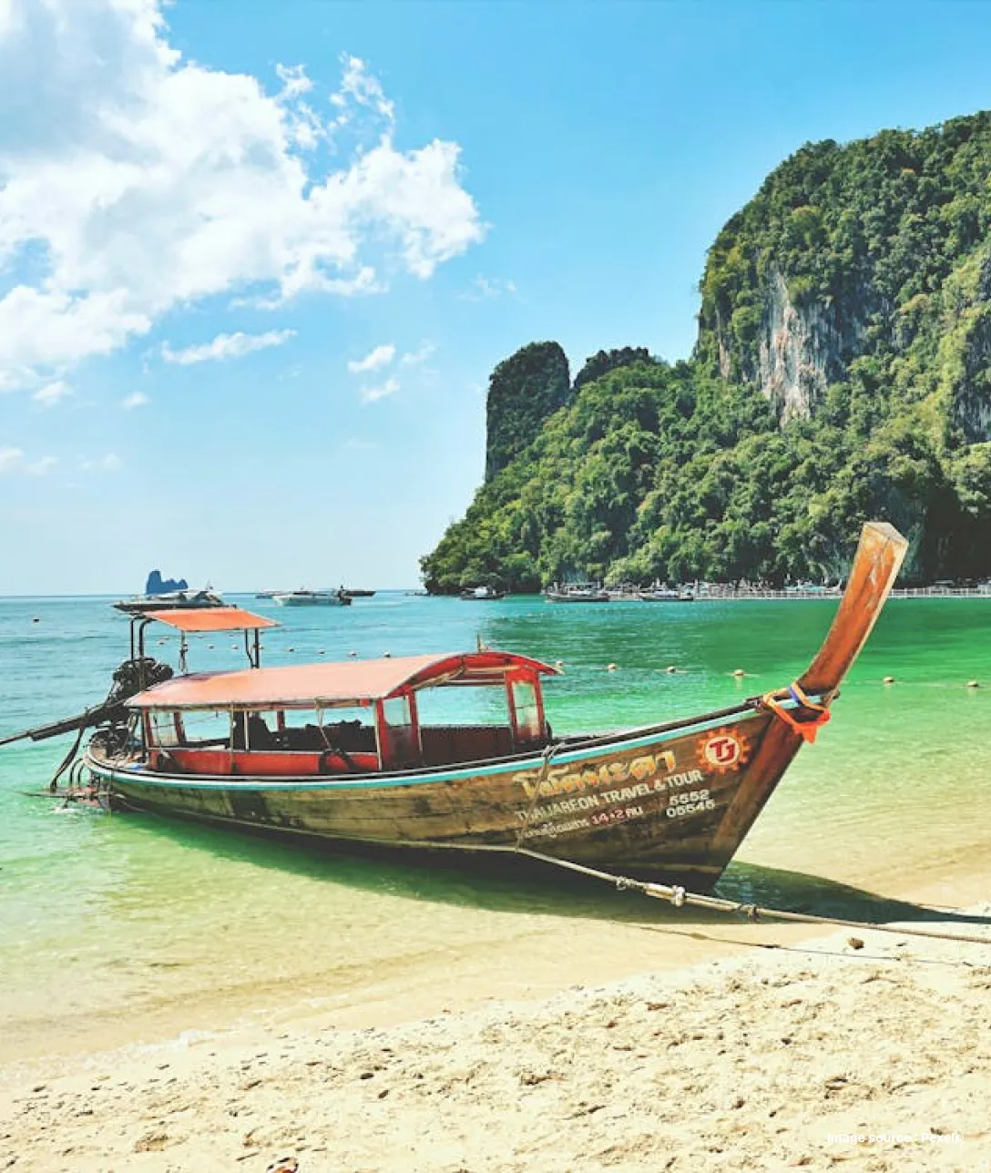 a traditional wooden boat parked at the shore in andaman