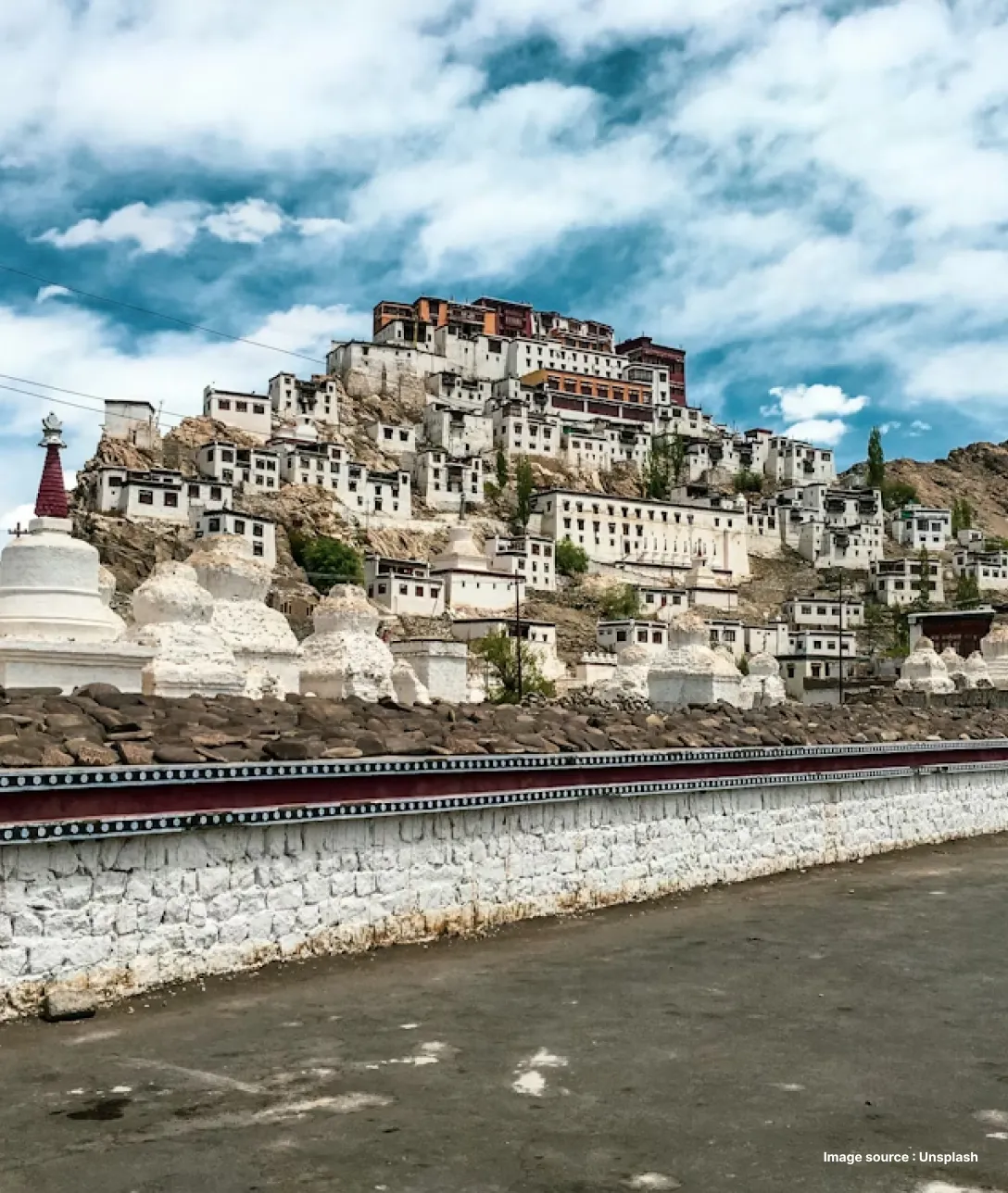 a distant shot of ancient white buildings in leh