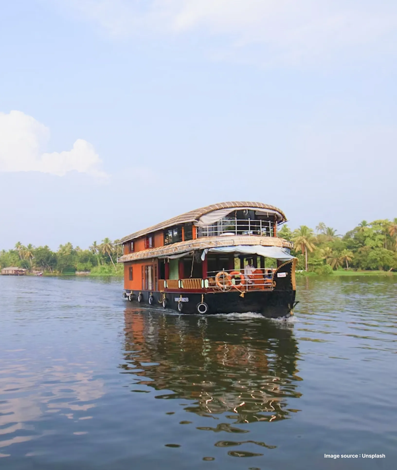 a tourist houseboat cruising the backwaters on a sunny day