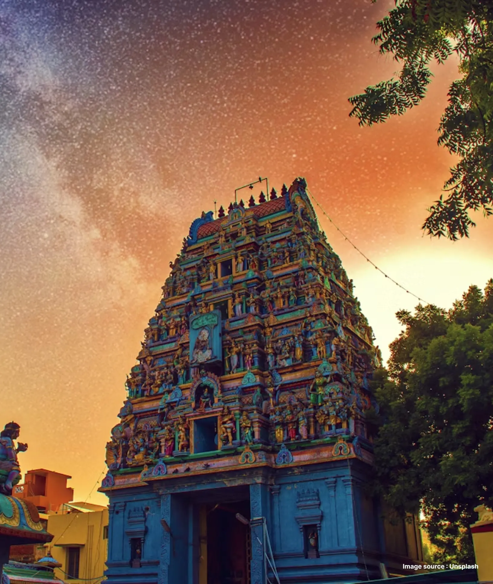 a colorful towering temple with intricate sculptures during sunset
