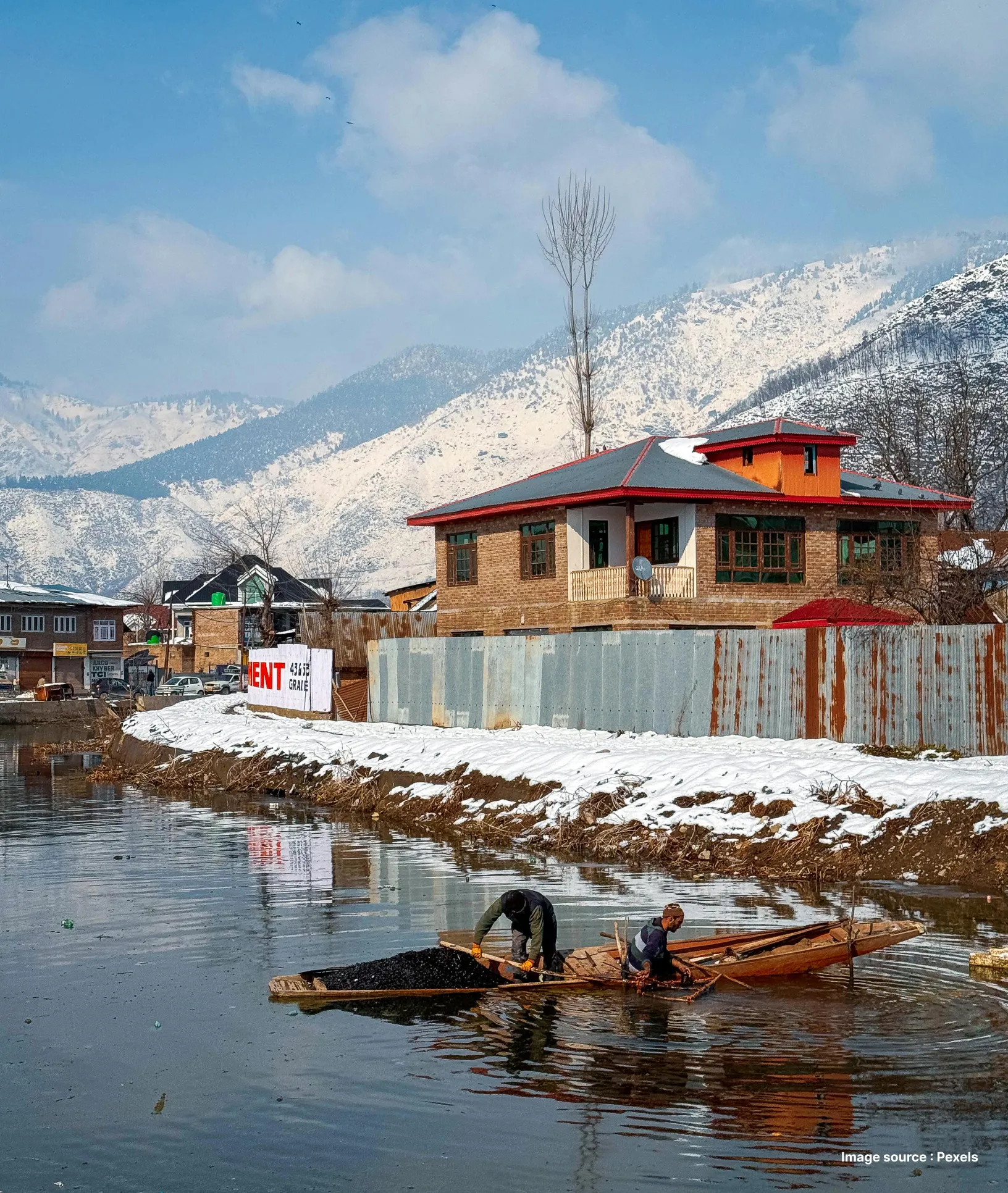 a wooden cottage against the backdrop of a snow capped mountain in gulmarg valley
