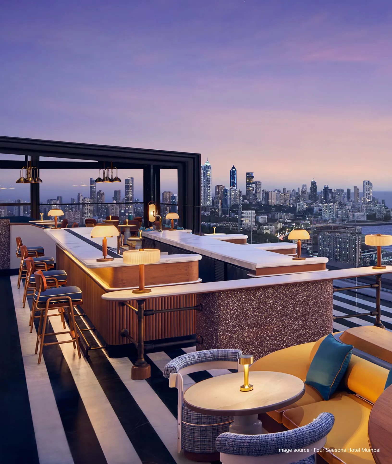 rooftop restaurant of four seasons hotel at sunset with skyline view of mumbai