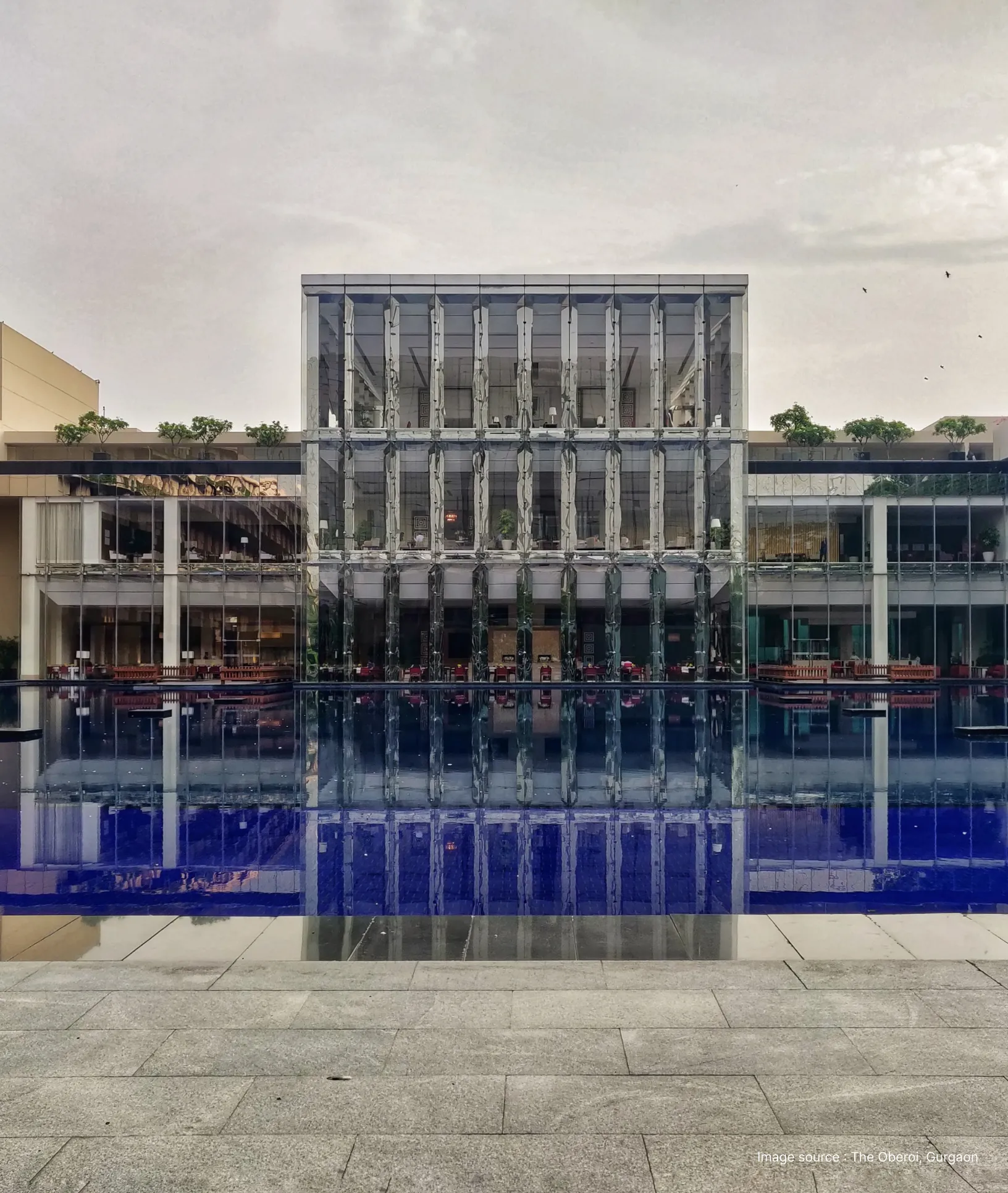 pool side view of the oberoi gurgaon on a cloudy day