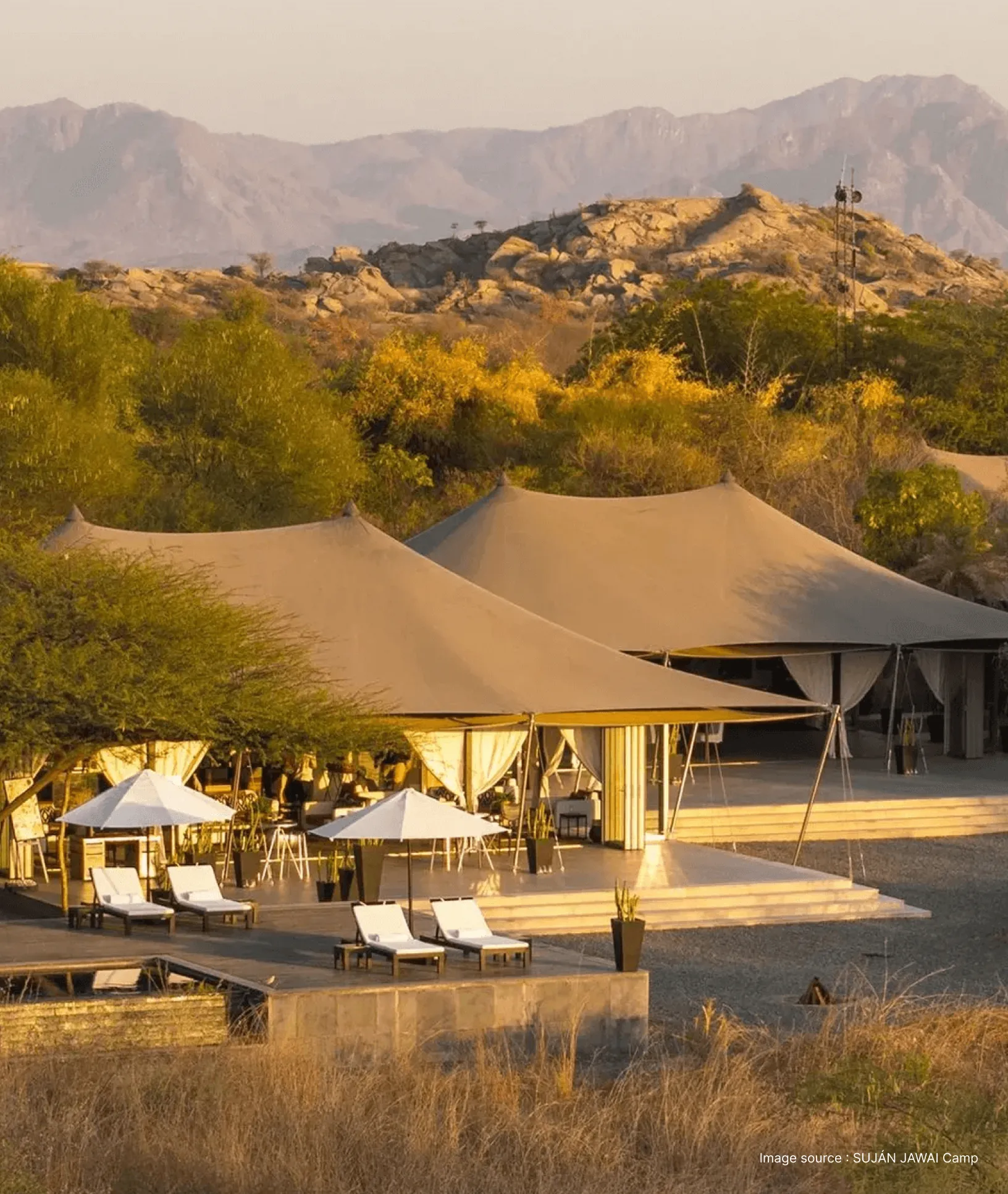 wide angle view of the SUJAN Jawai camp with premier tented suites in the afternoon and hills in the backdrop