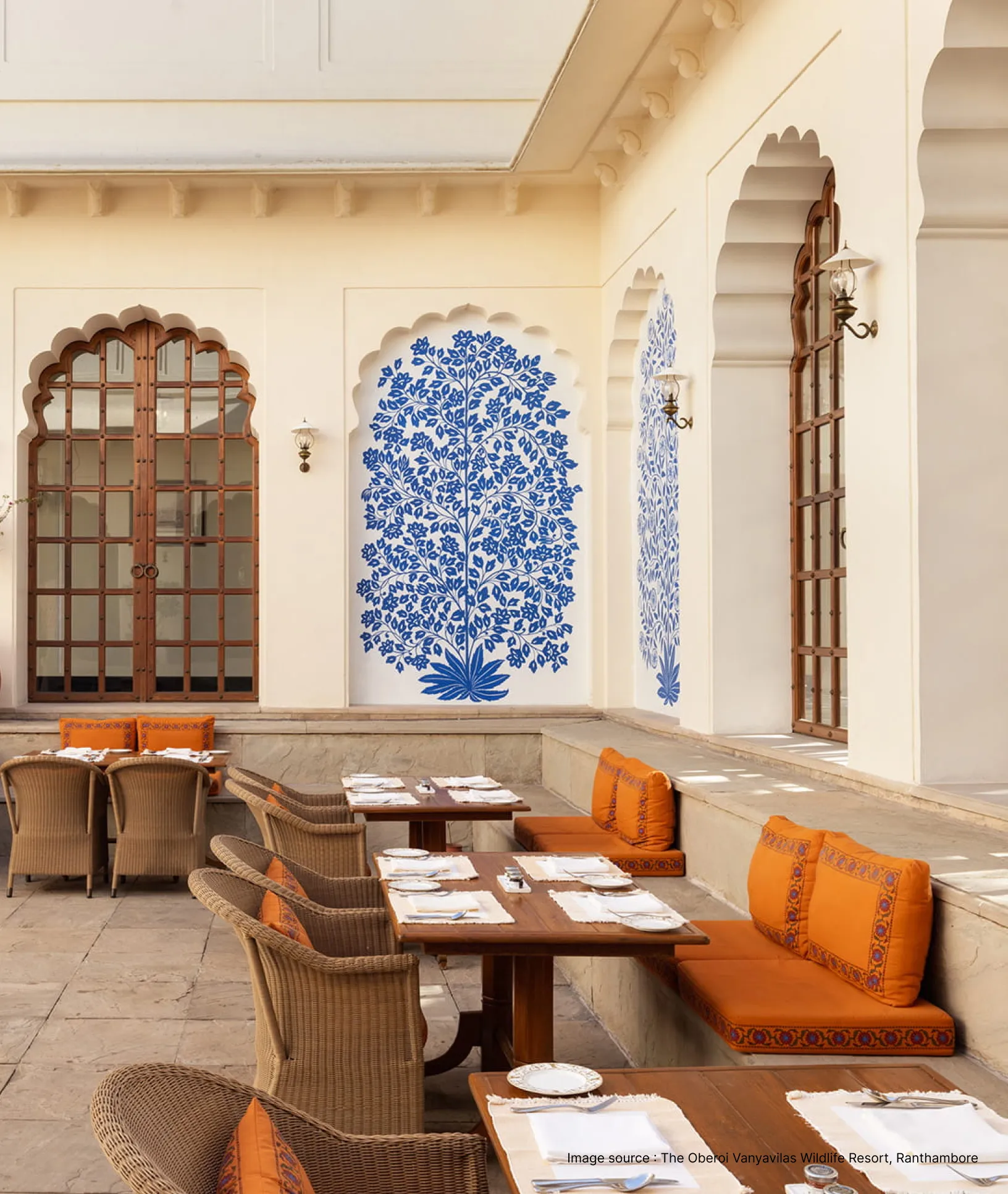 dining area with a blue detailed painted wall in the oberoi vanyavilas resort
