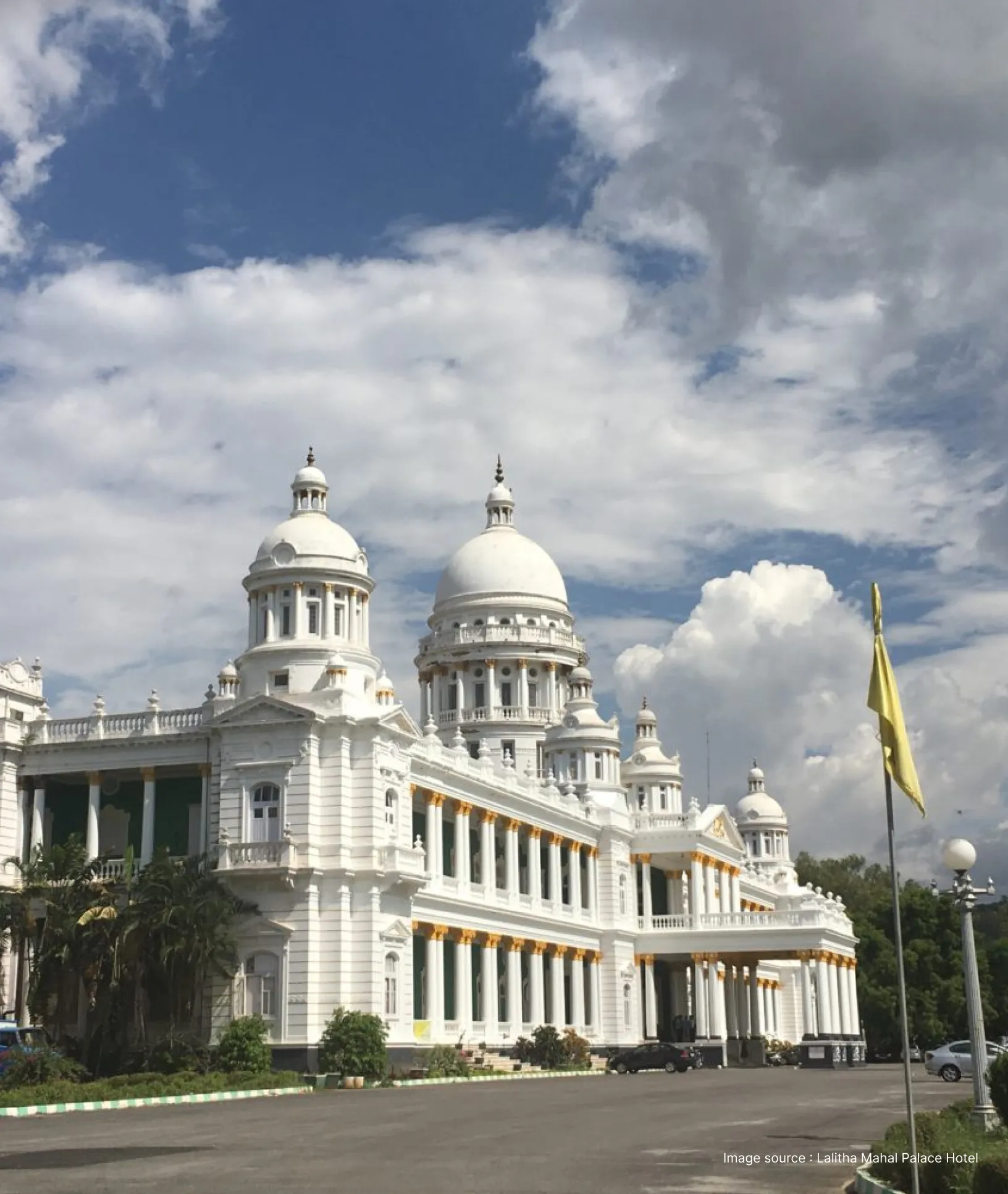 white victorian era architecture at the lalitha mahal palace with a cloudy sky
