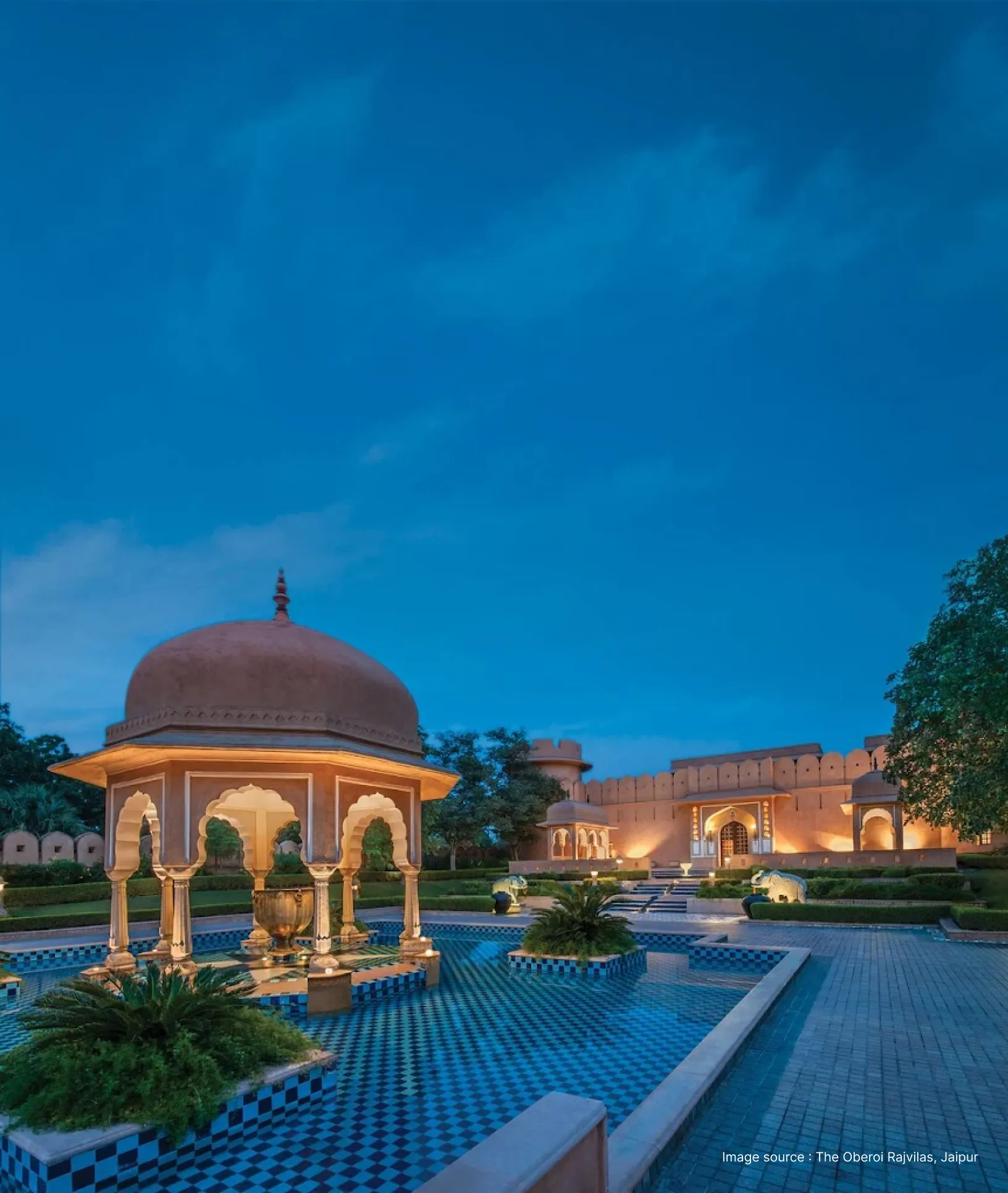 cenotaph and pavilion lit up in the evening at oberoi rajvilas