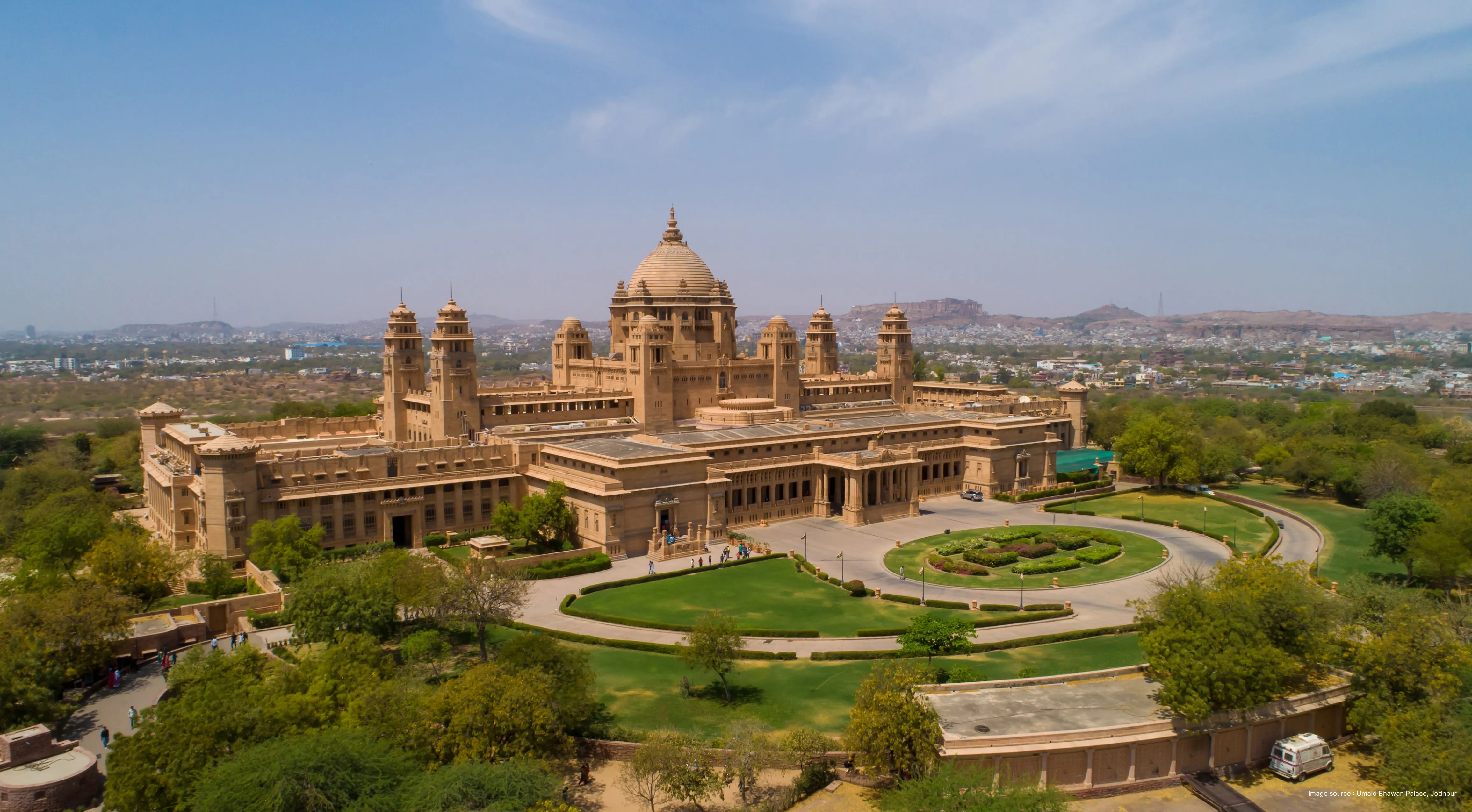 aerial shot of the grand umaid bhawan palace with its gardens and opulent building