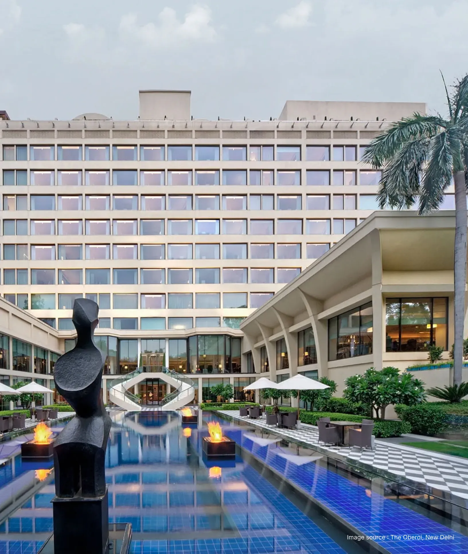 pool side view of the oberoi hotel in new delhi with its modern building