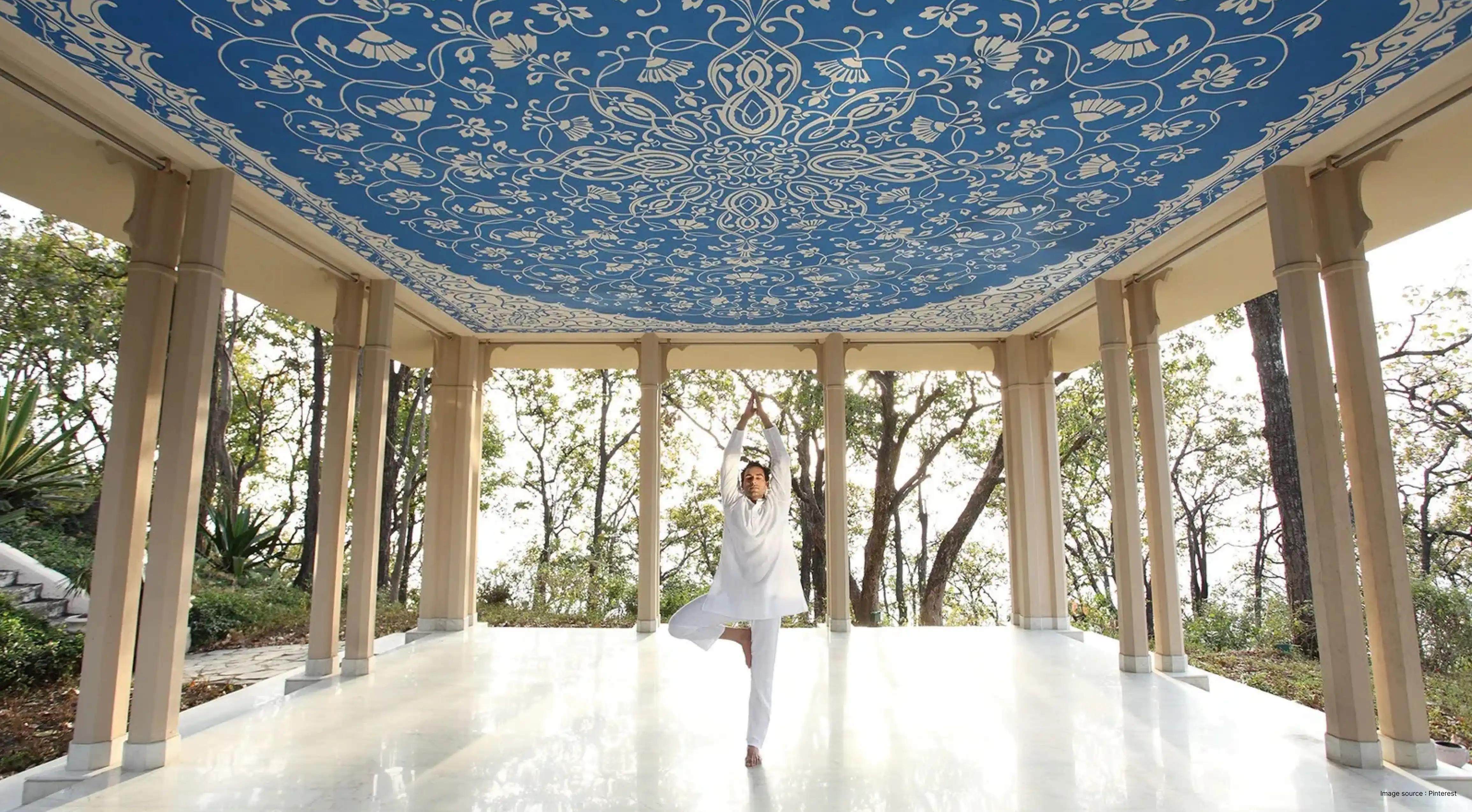 A lady doing a yoga pose in the porch of a Himalayan Resort