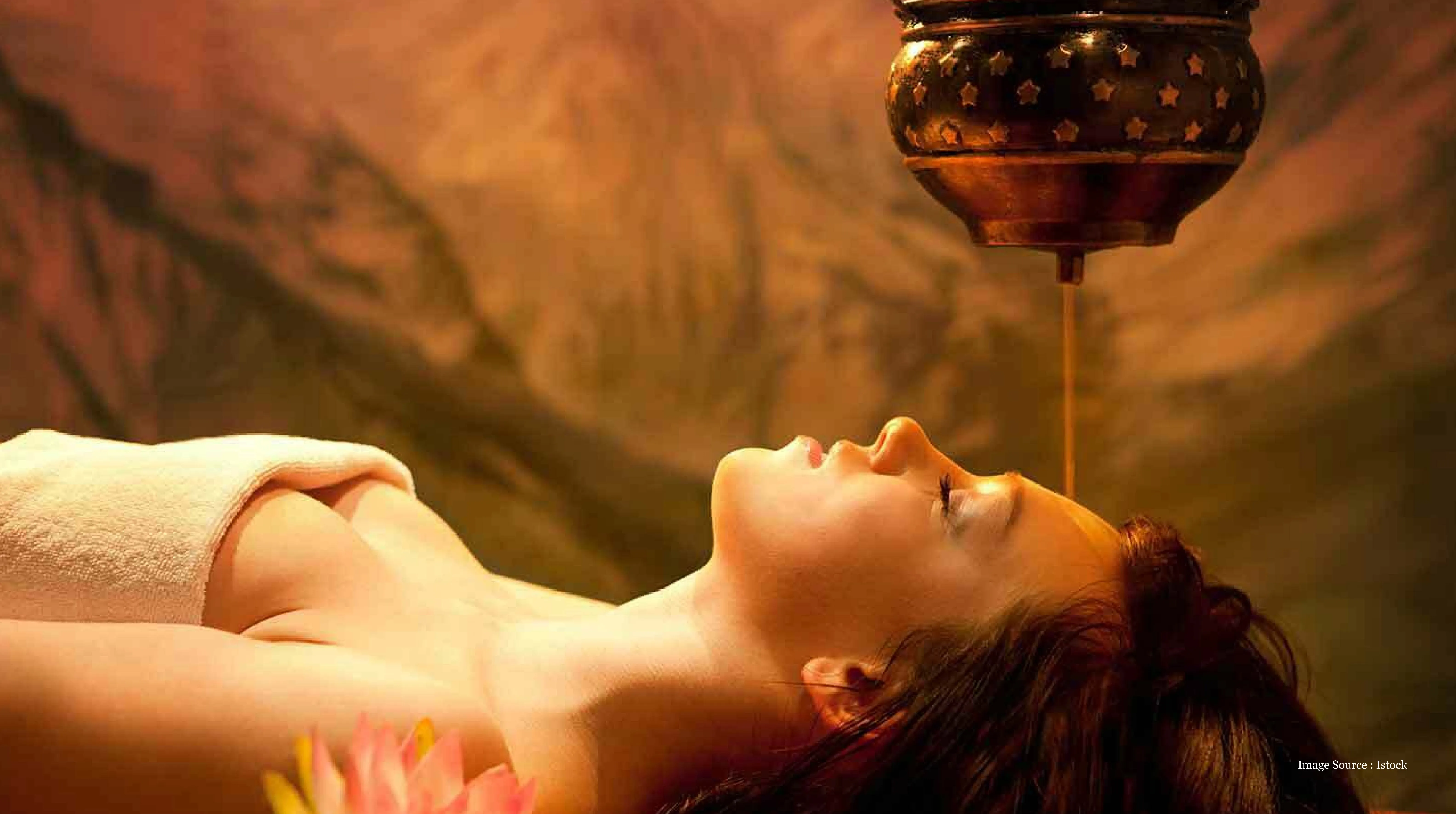 Kerala-vs-Goa luxury tour wellness experience featuring a soothing Ayurvedic spa treatment with warm herbal oil gently poured on the forehead for relaxation