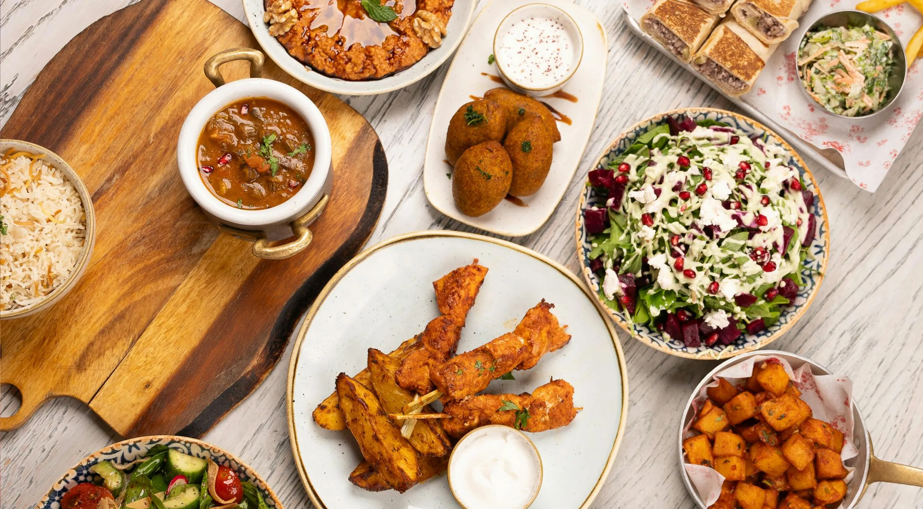 a spread of delicious middle eastern delicacies with meat dishes & freshly made spreads