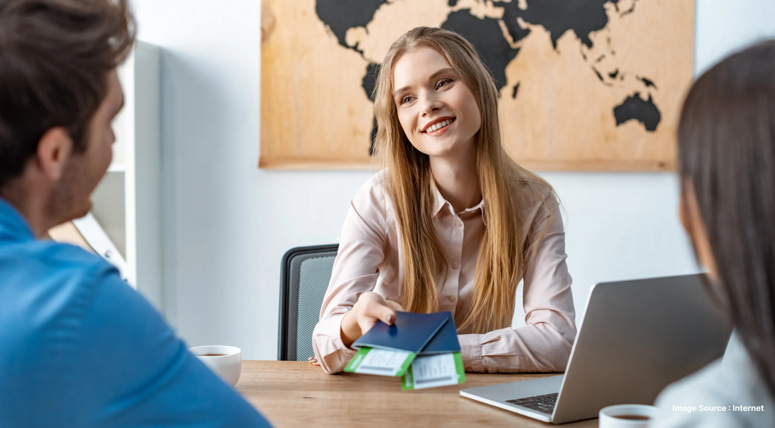 travel advisor with flight tickets in hand speaking with clients