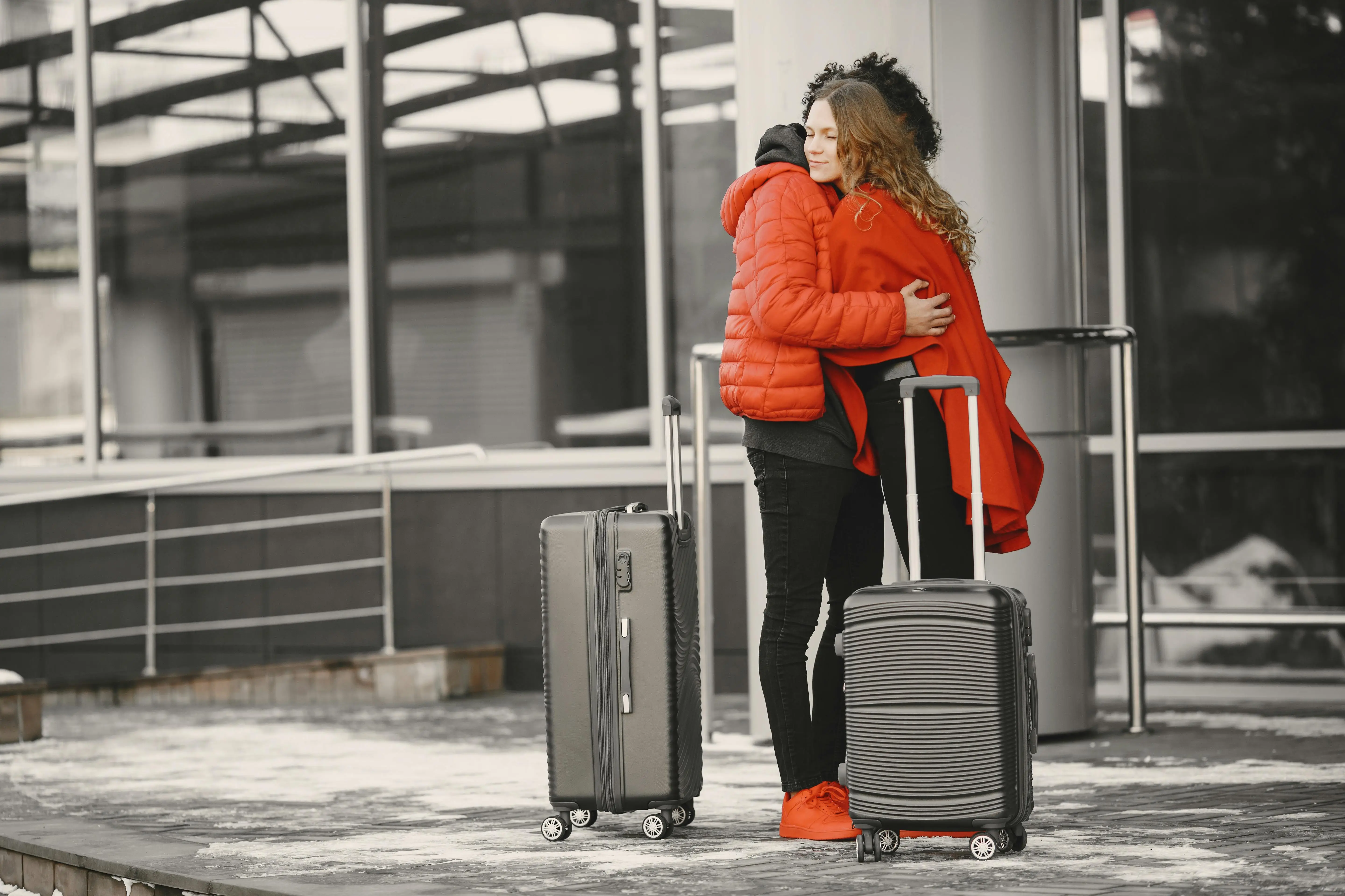 a couple hugging each other at airport
