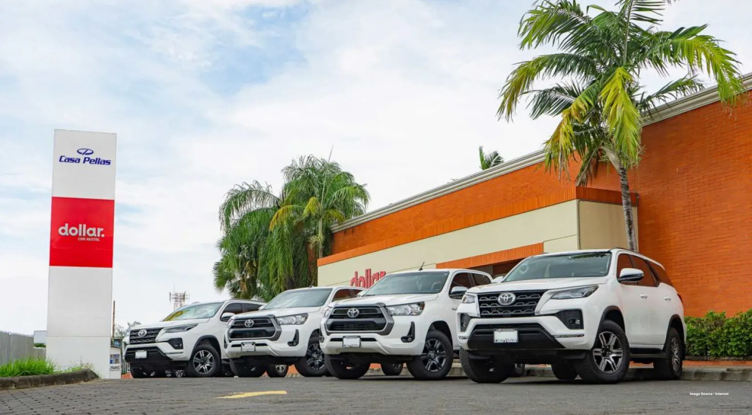 4 toyota suv cars parked in front of dollar car rental service