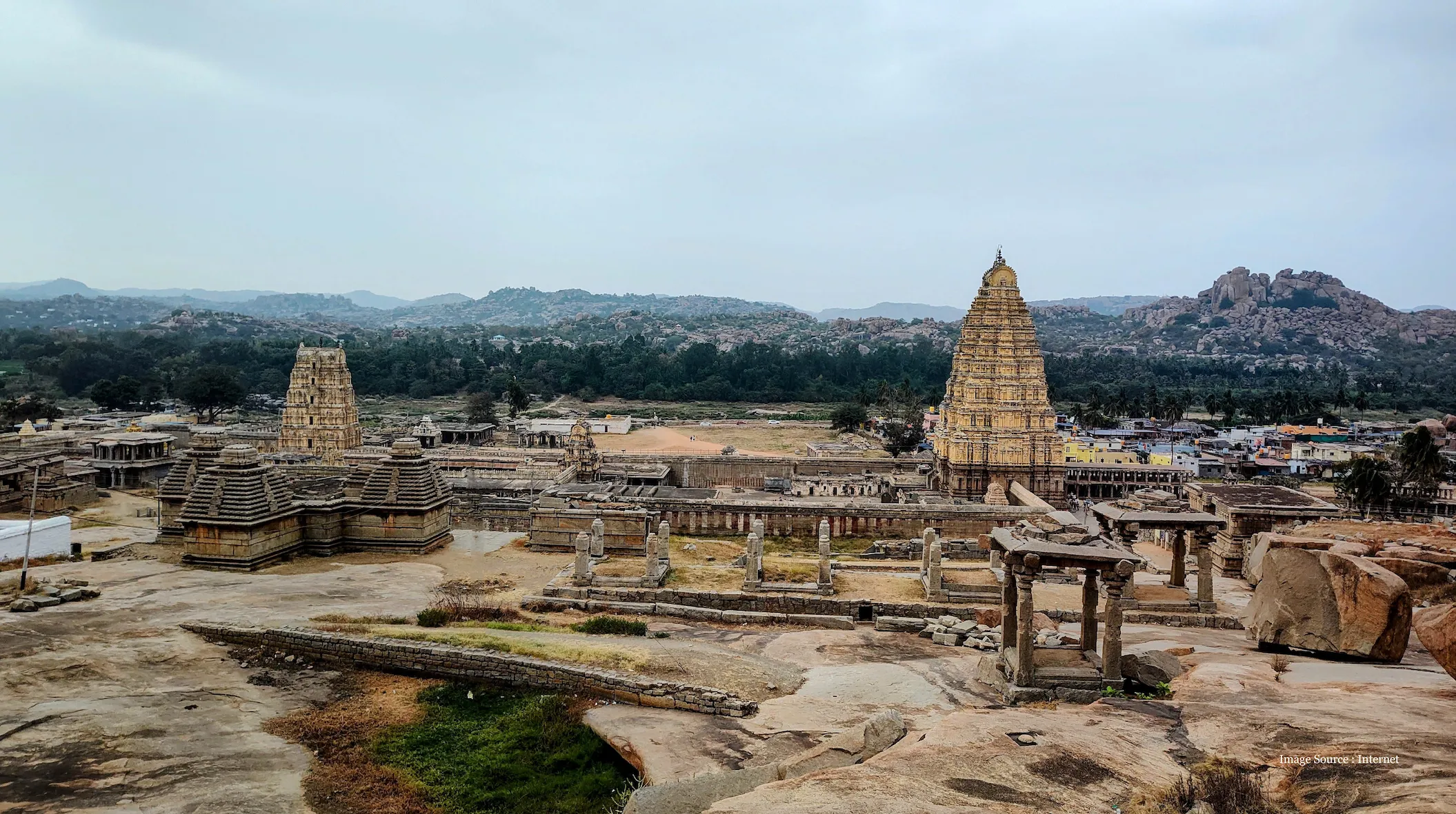 India cool places to visit featuring the ancient ruins and iconic temples of Hampi, set amidst dramatic boulder-strewn landscapes and lush greenery
