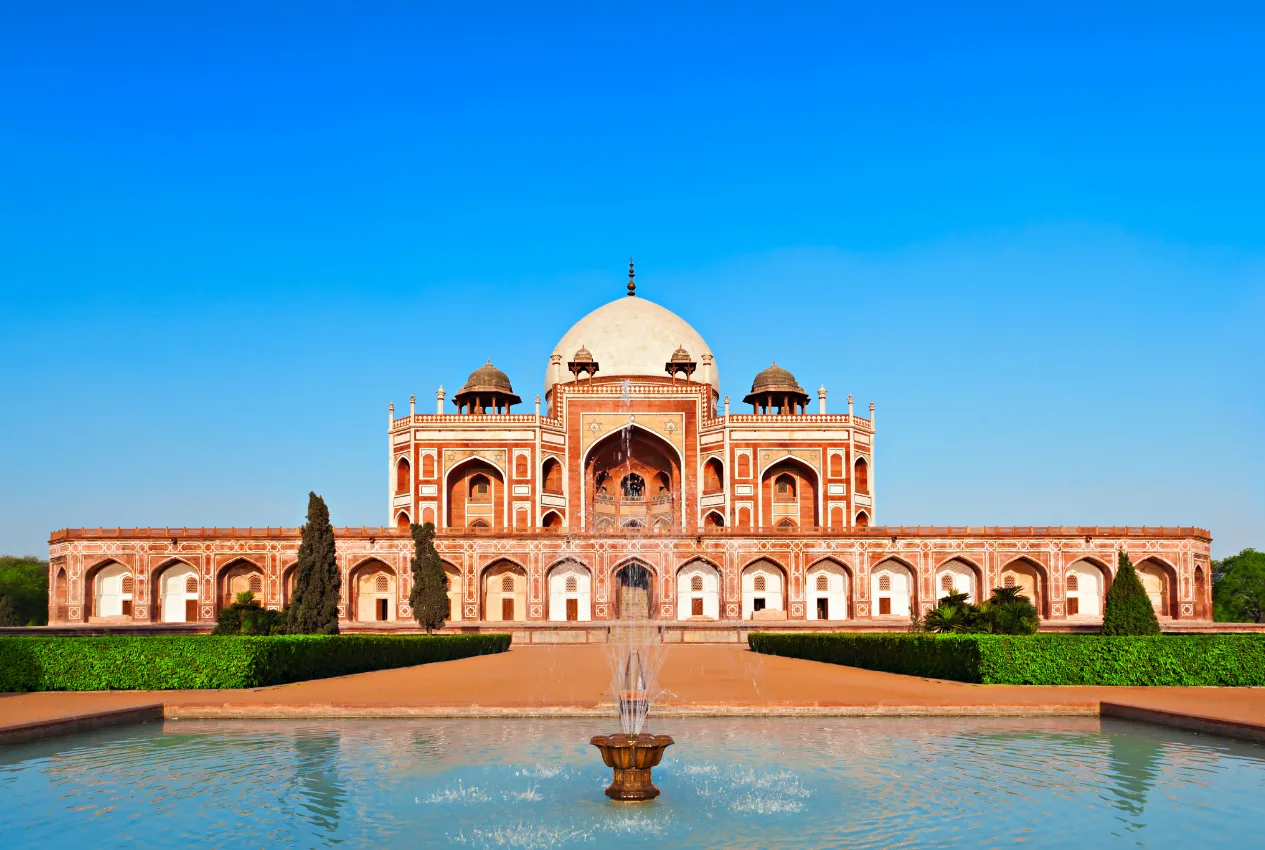 Golden triangle: Humayun's Tomb in Delhi, historic Mughal architecture with fountain and gardens under clear blue sky