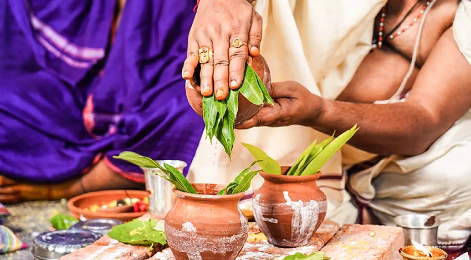 a sacred pitcher being decorated ceremoniously with leaves by a priest