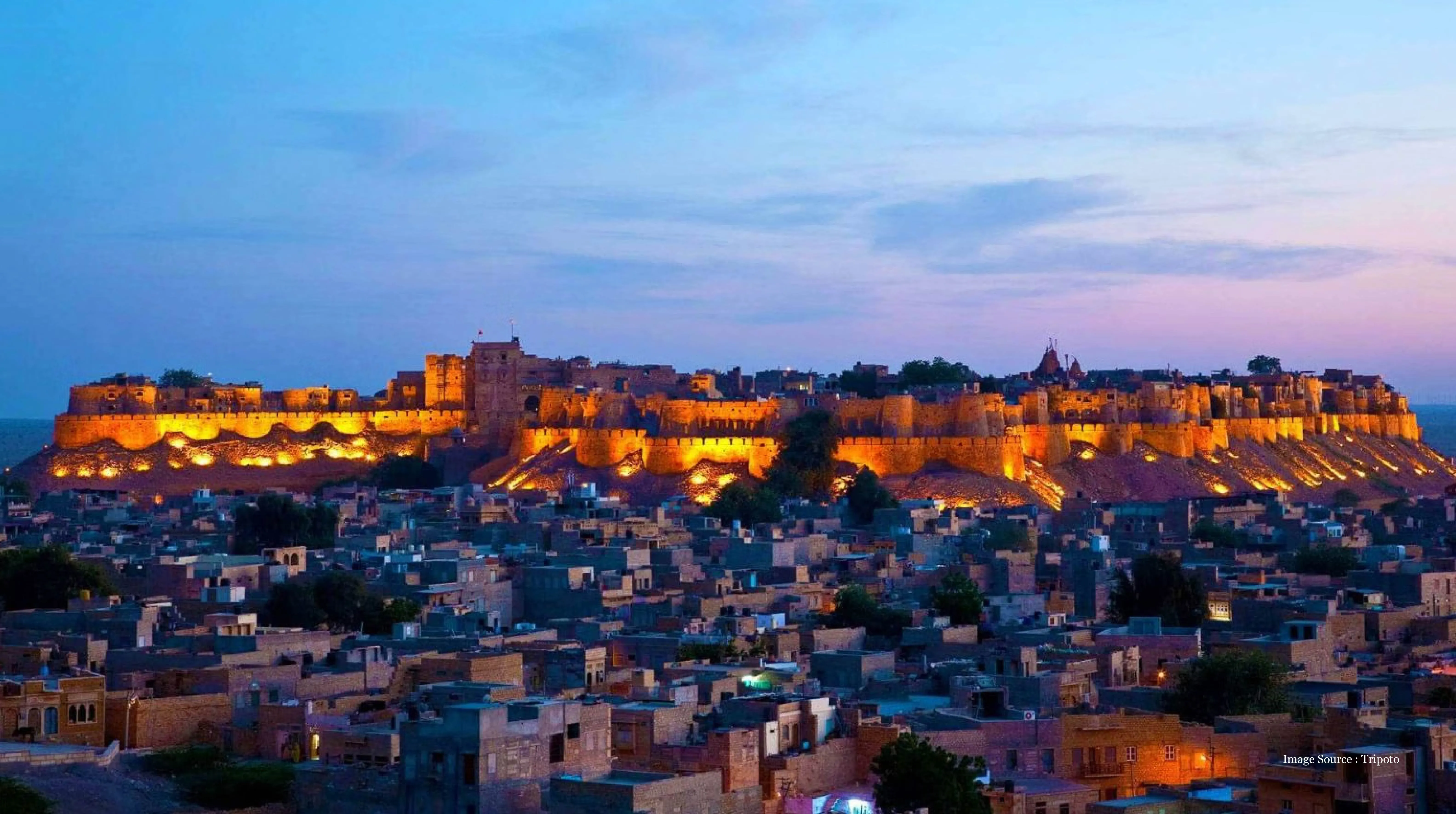 How much should you spend on a Rajasthan royalty experience with a magical view of Jaisalmer Fort illuminated at dusk above the golden city’s charming heritage buildings