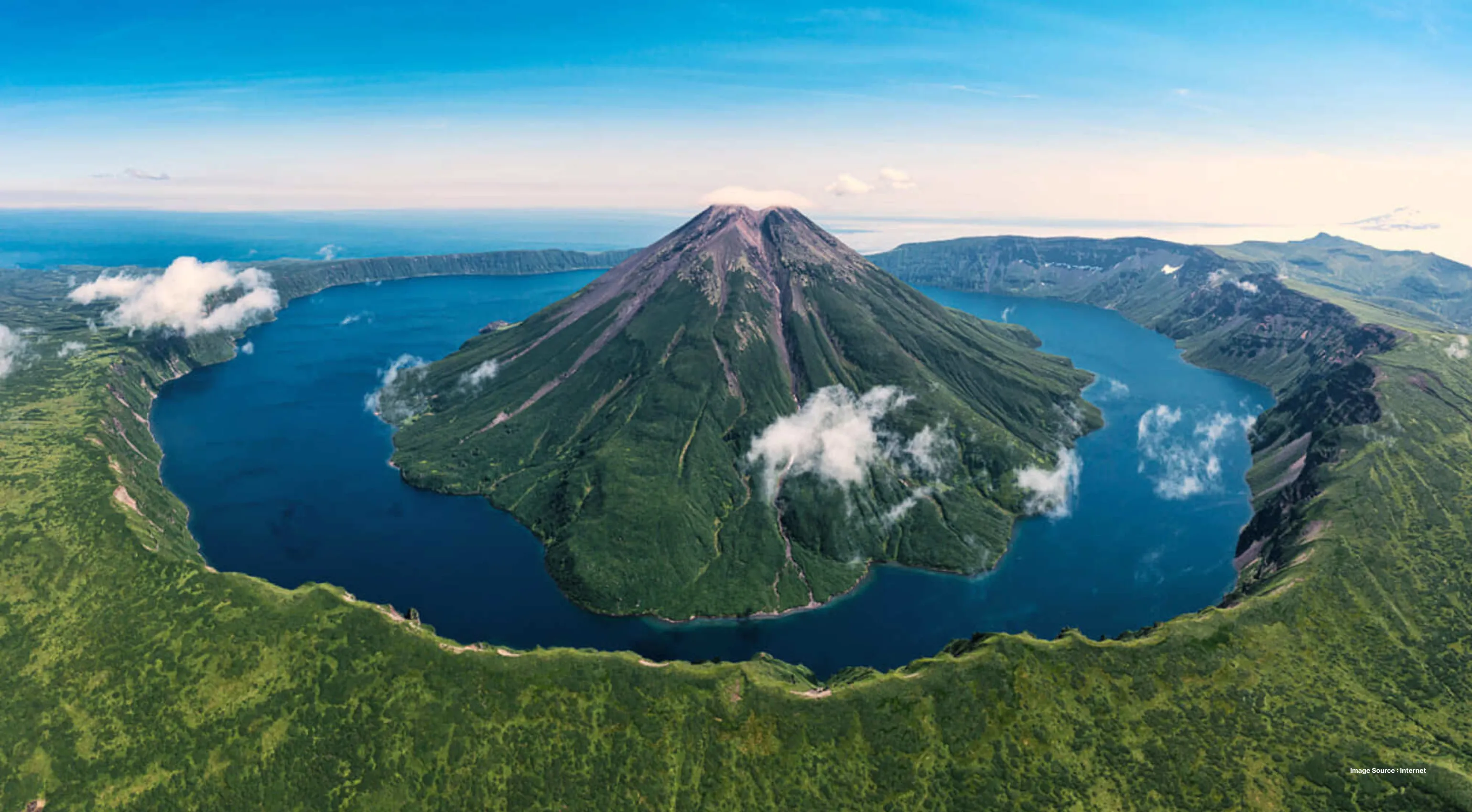 aerial shot of the kuril islands with greenery and a hill in middle