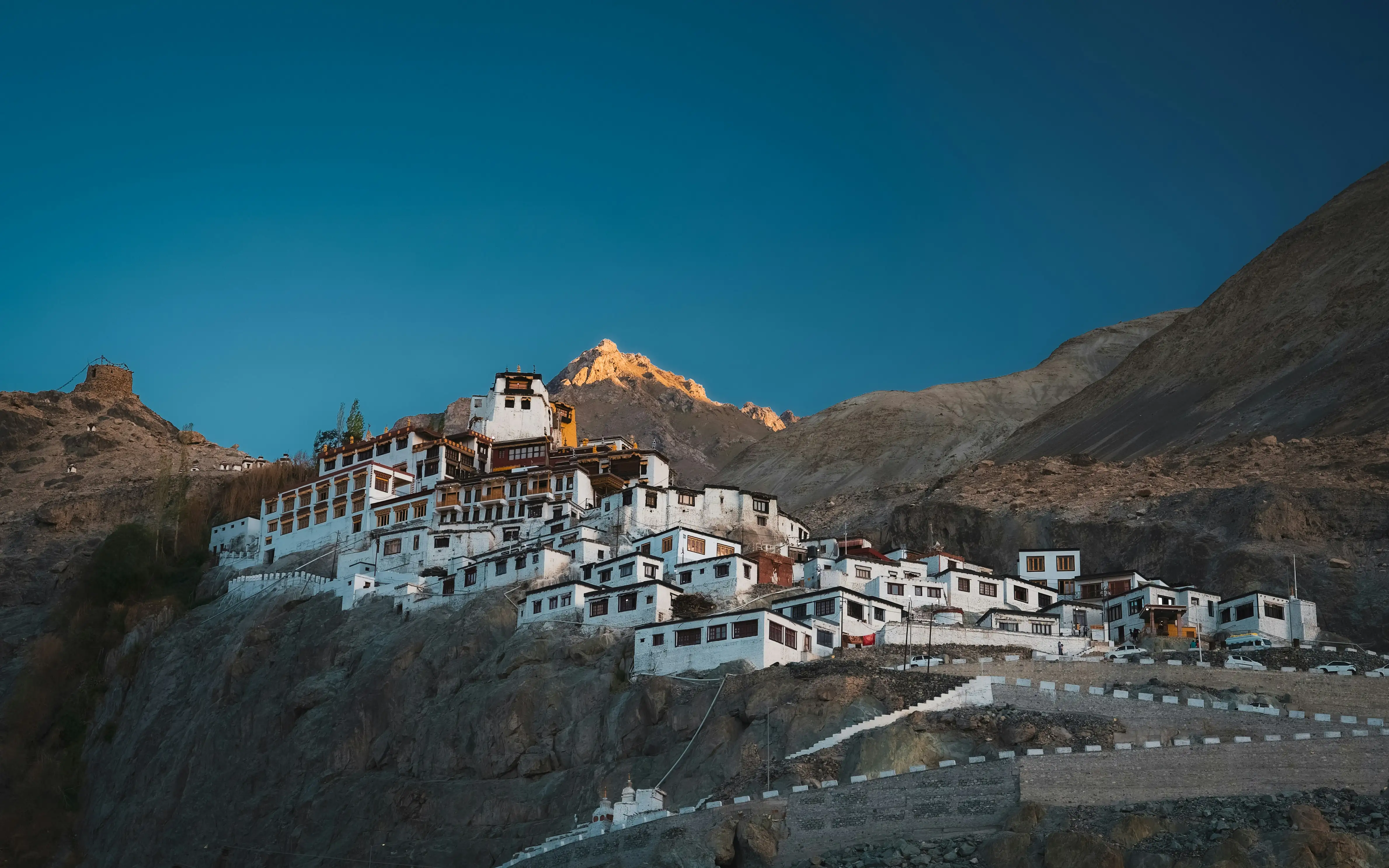 the thiksey monastery in leh with ethereal white buildings on a small valley