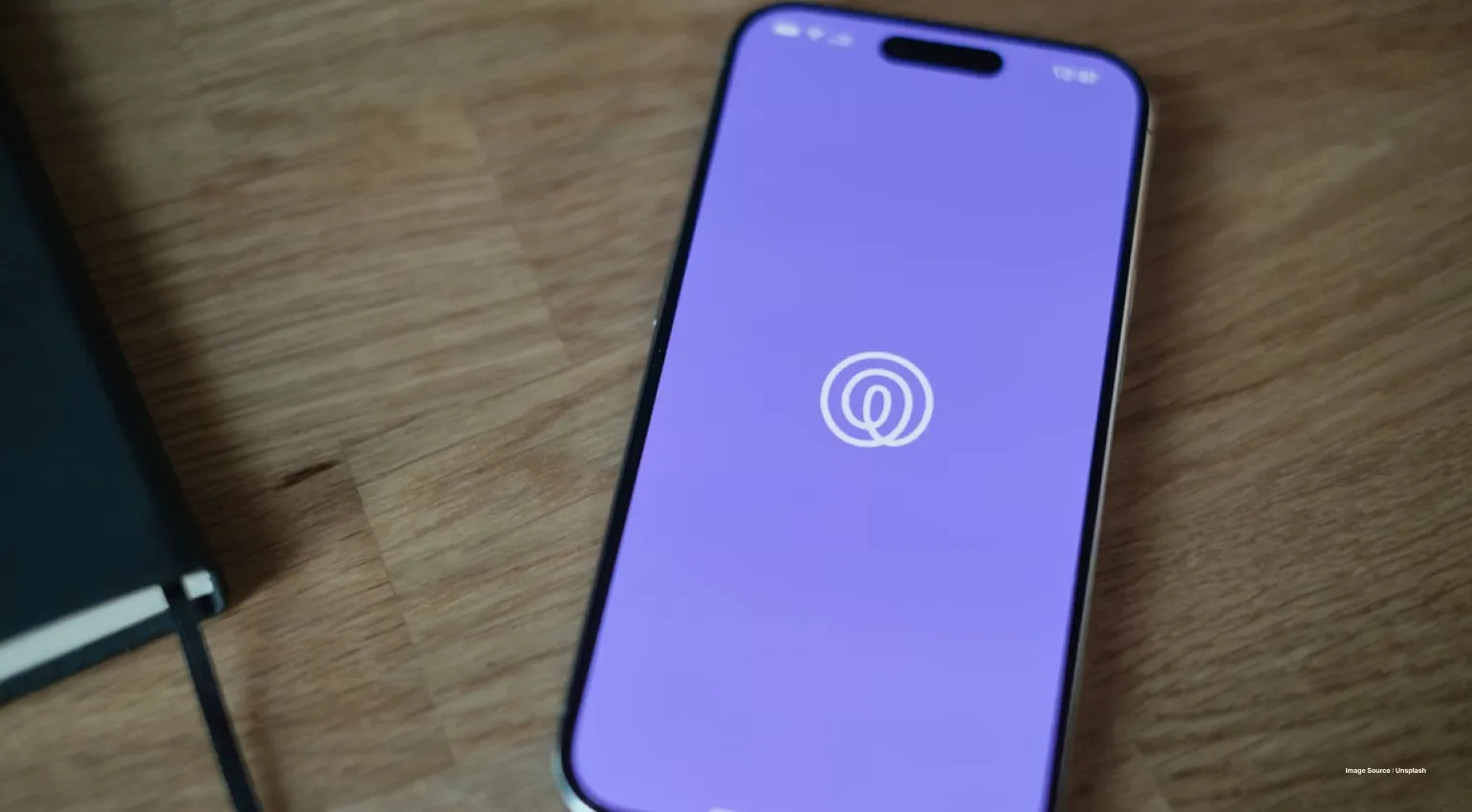 a phone kept on the table open with a purple solid background and life360 logo
