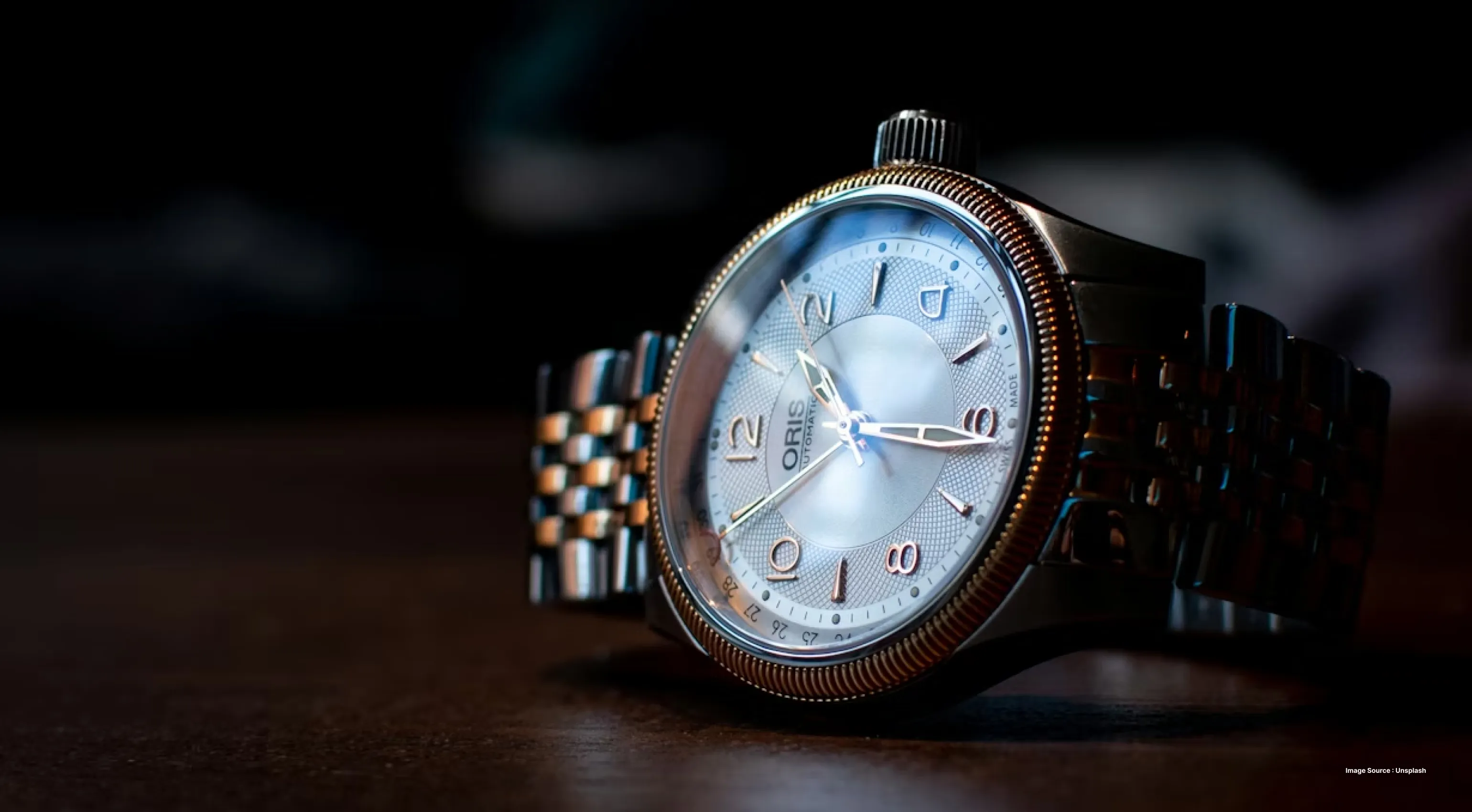 close up of a premium watch lying sideways in a dark space