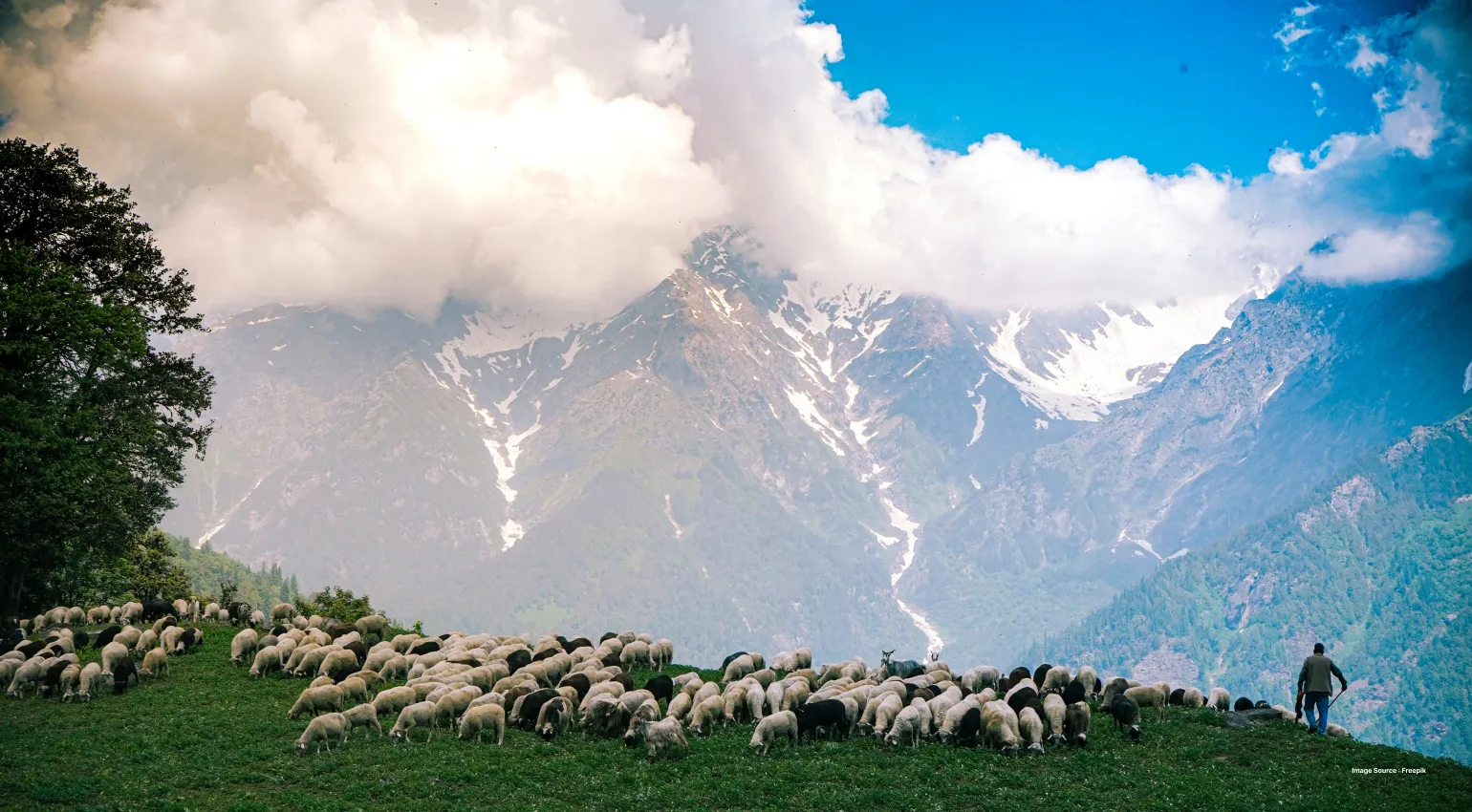a beautiful shot of mountains with huge clouds