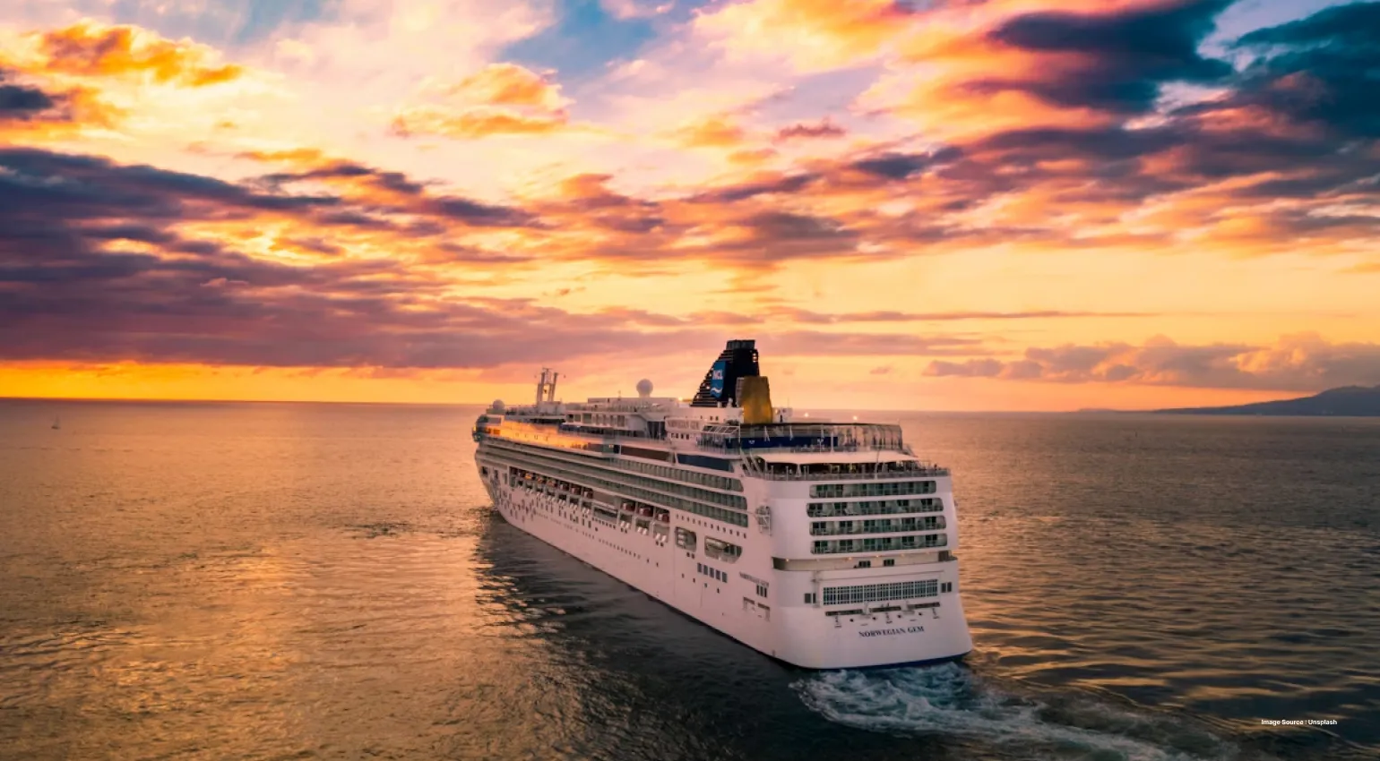 a beautiful sunset view of a large cruise ship cruising on the sea