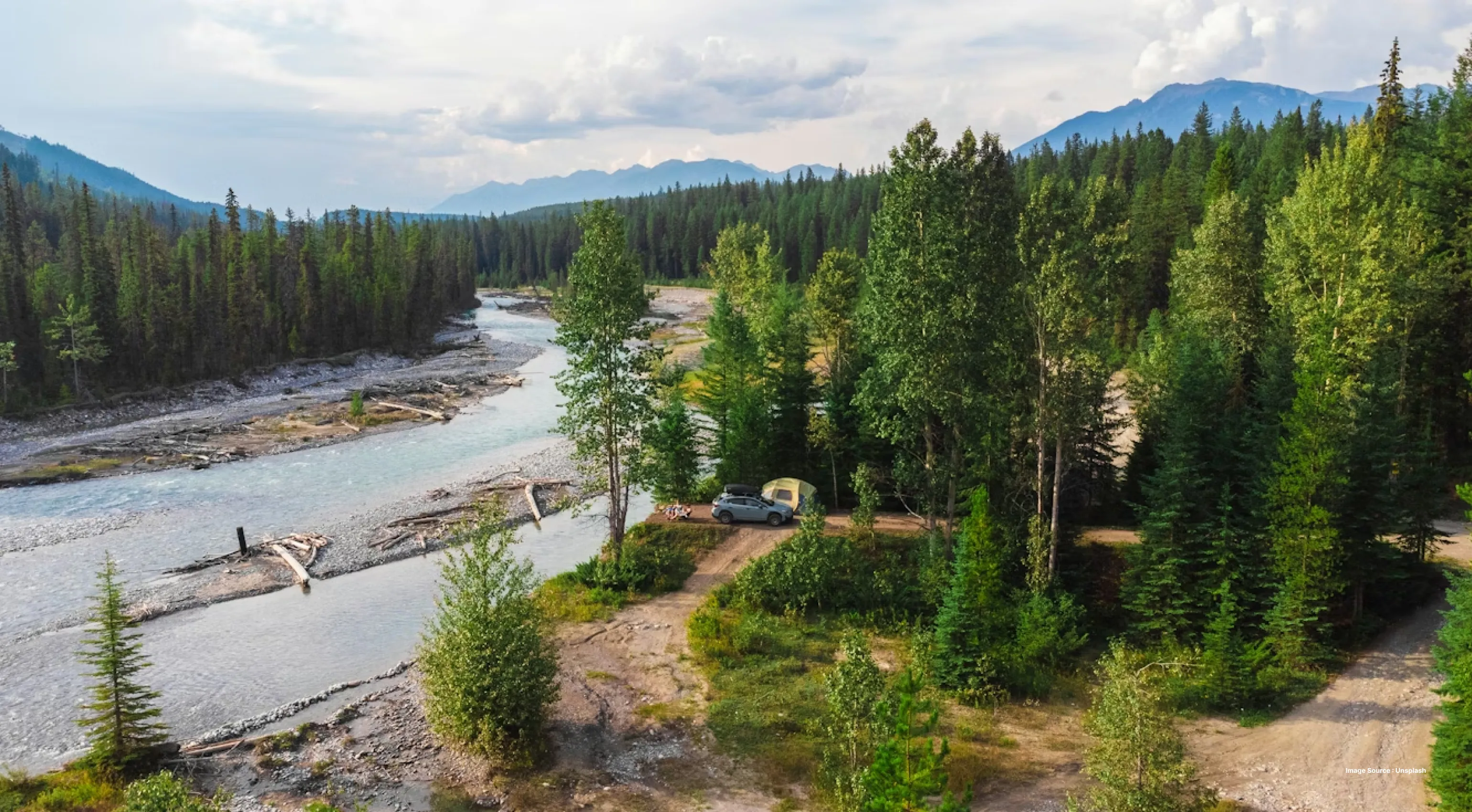 landscape view of spread creek with river and trees and mountains in a distance