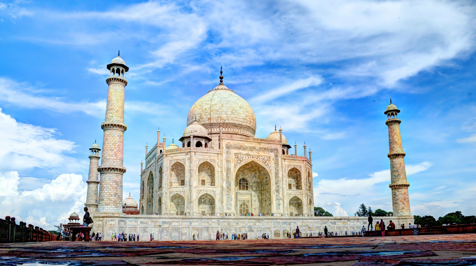 Taj Mahal group tour: visitors exploring the iconic monument under a beautiful sky