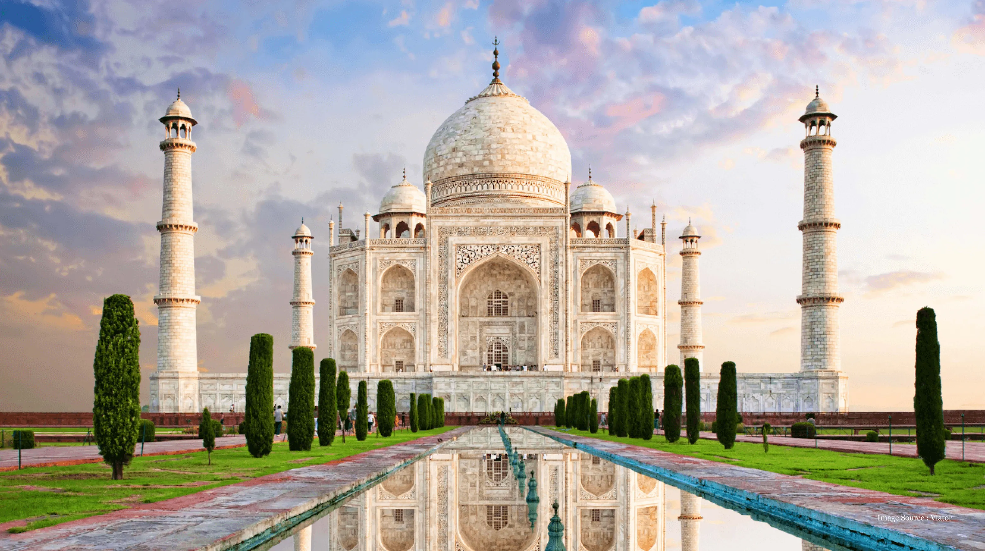 india-itinerary: Majestic Taj Mahal in Agra reflected in water under beautiful sunrise sky