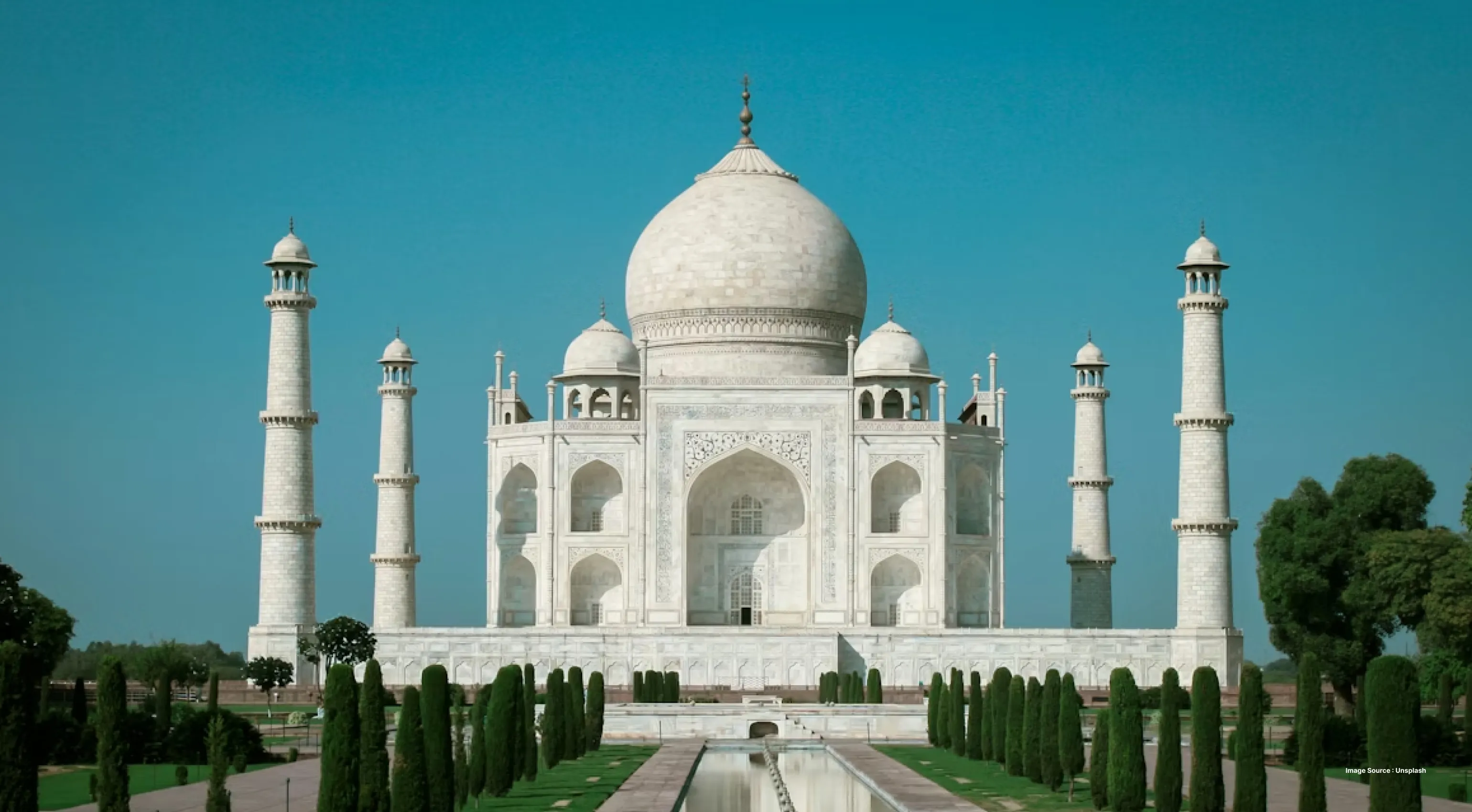 a daytime view of the iconic taj mahal from the front entrance gate